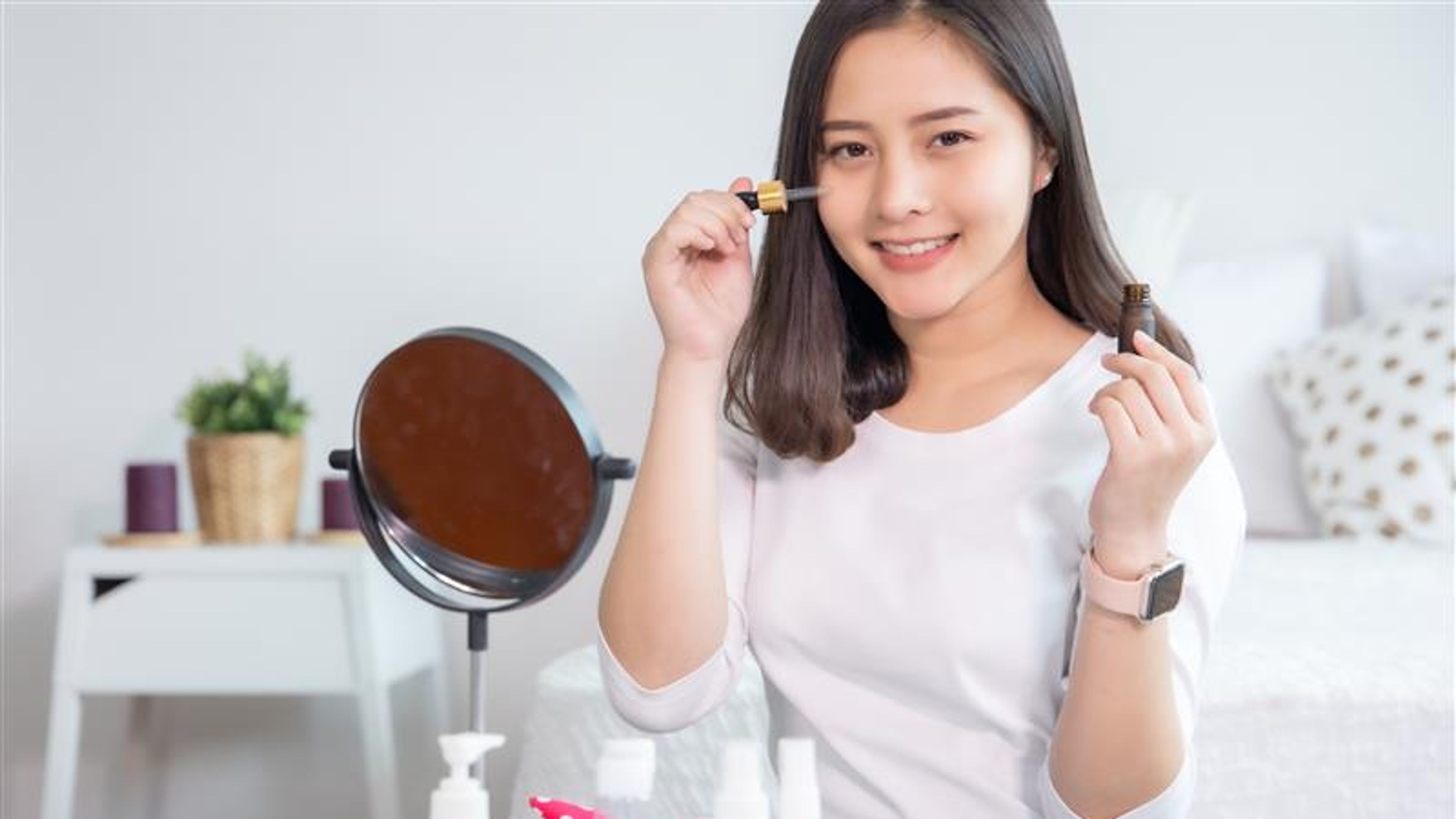 Asian girl is using beauty products