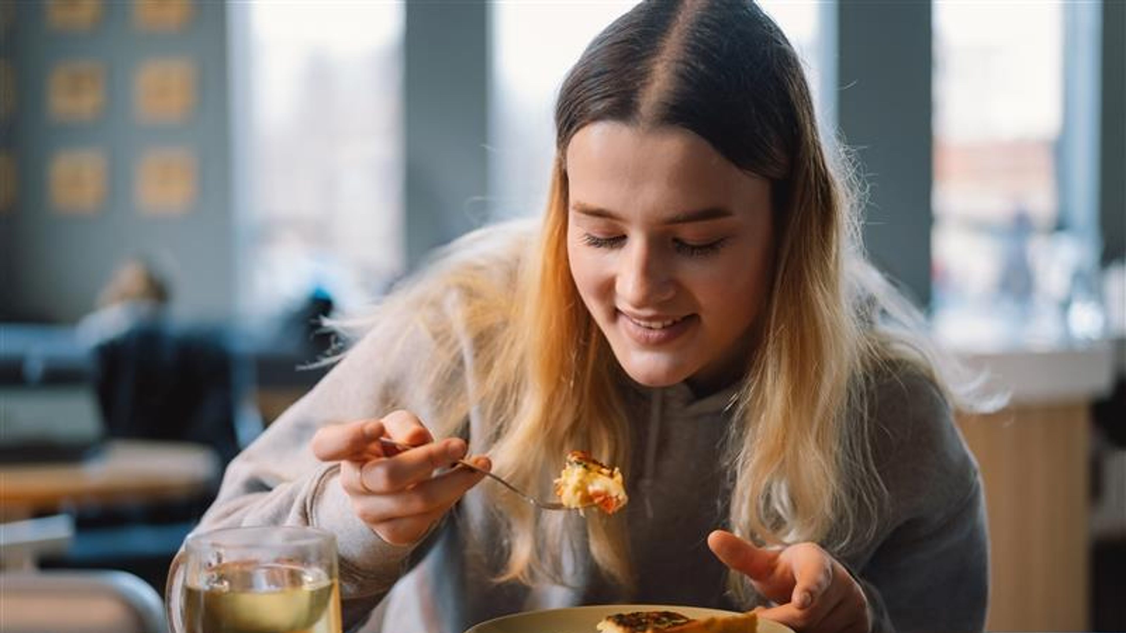 
A woman tasting food