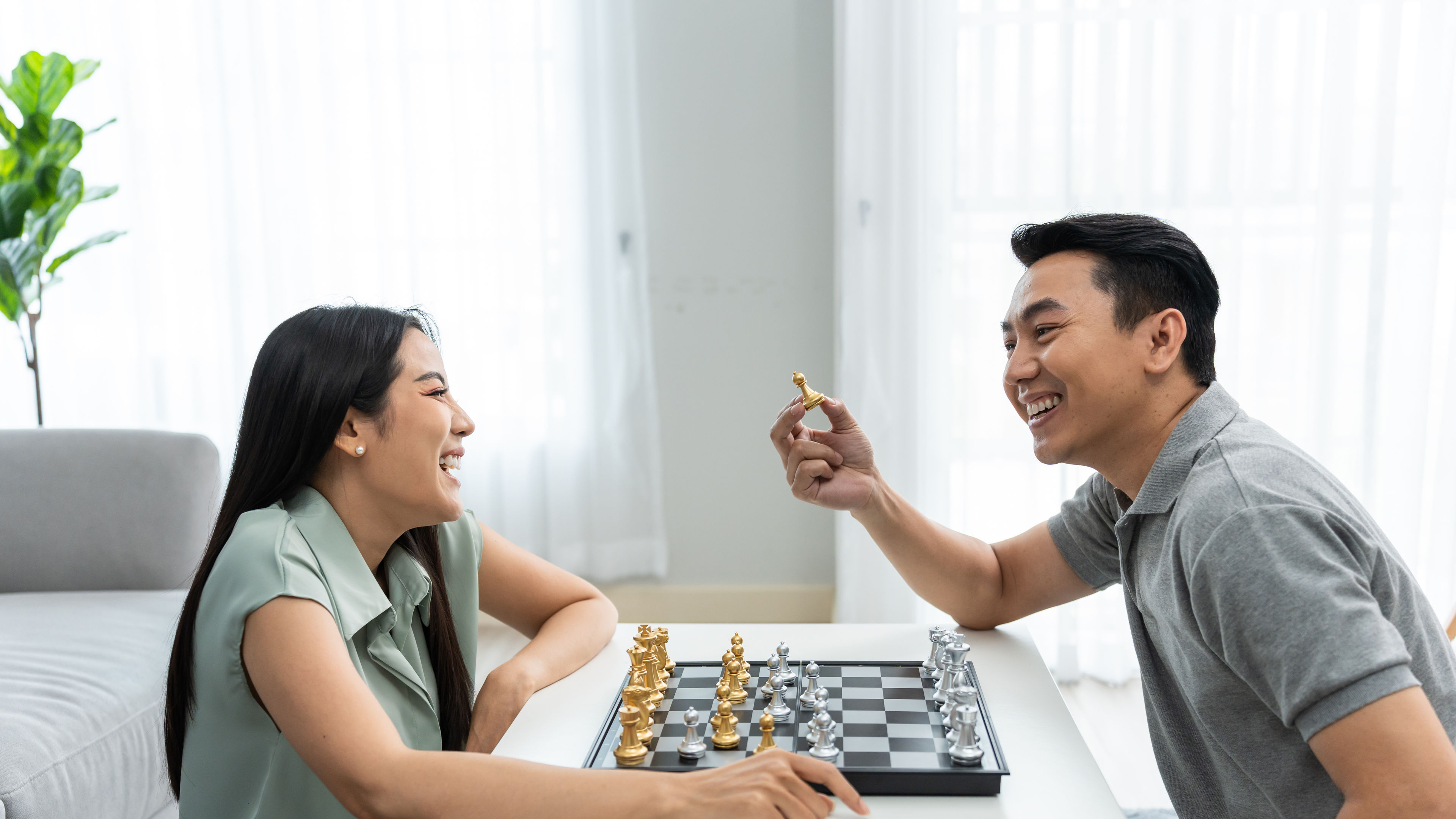 A couple playing chess together. 