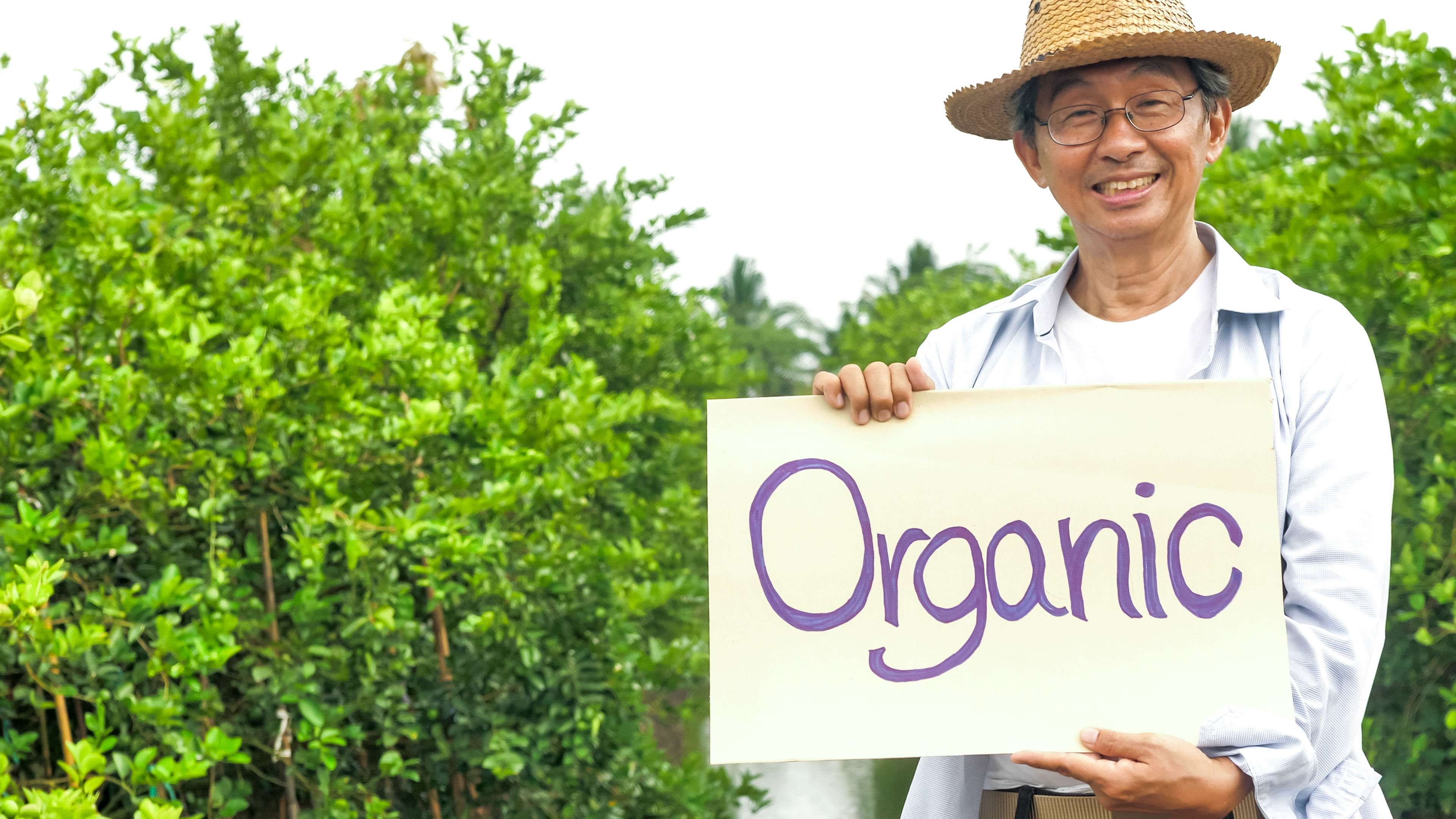 A man with a board on organic food in hand