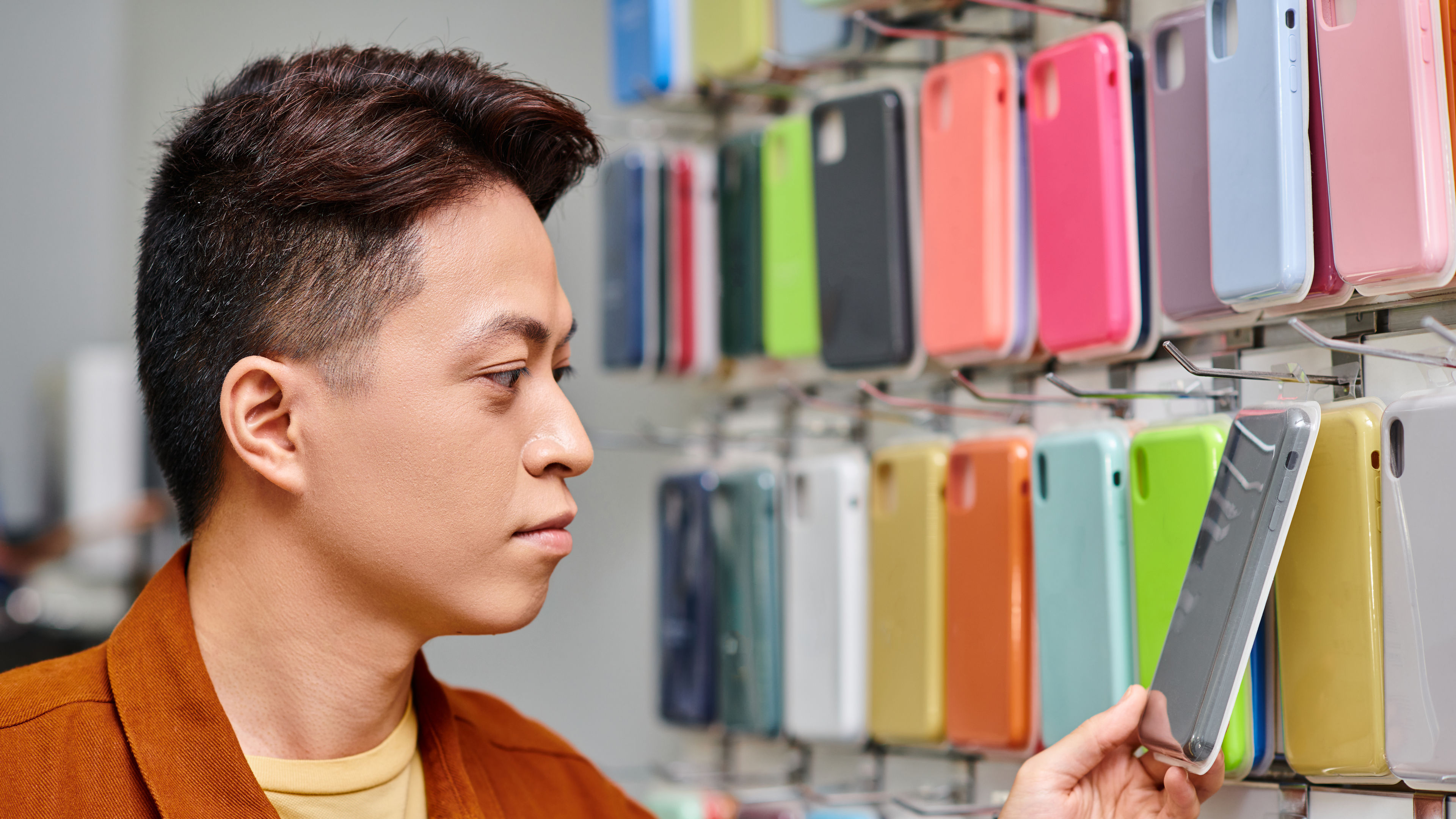 asian entrepreneur looking at colorful phone 