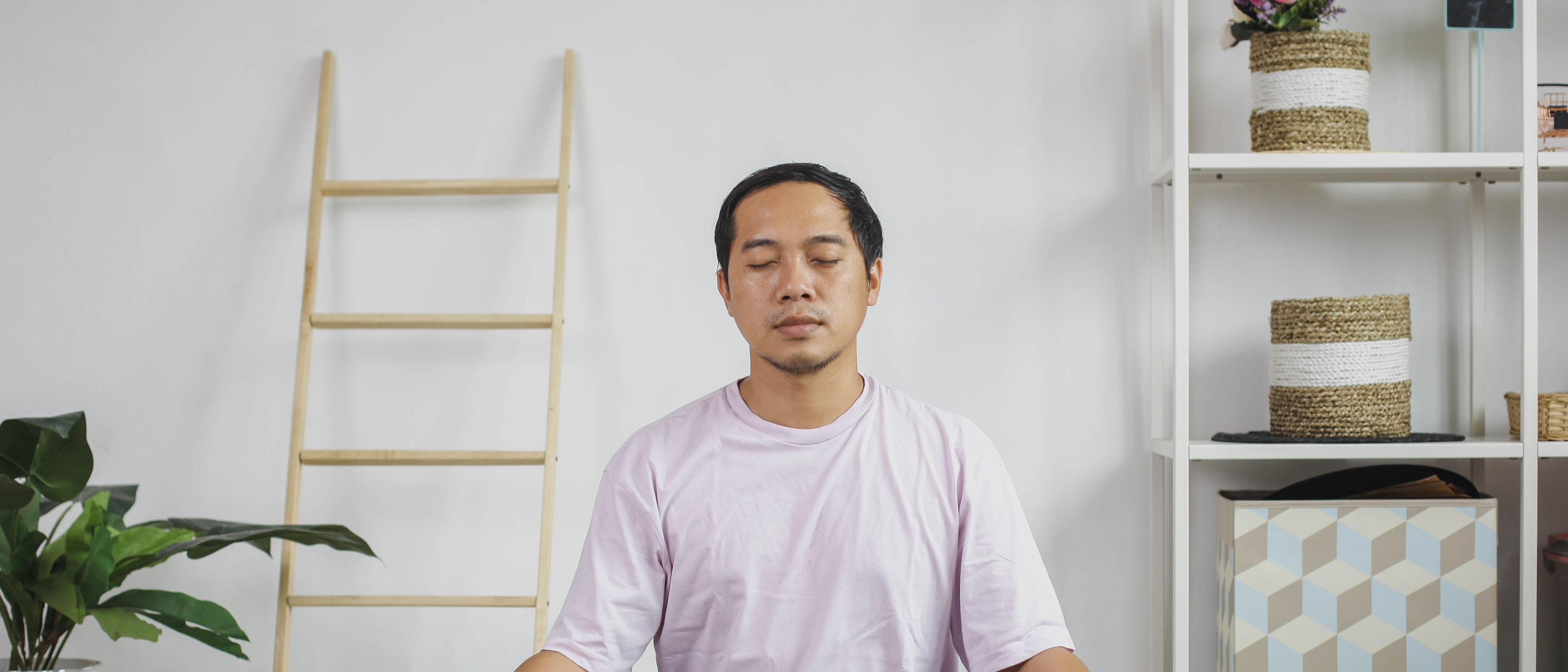 Man meditating at home