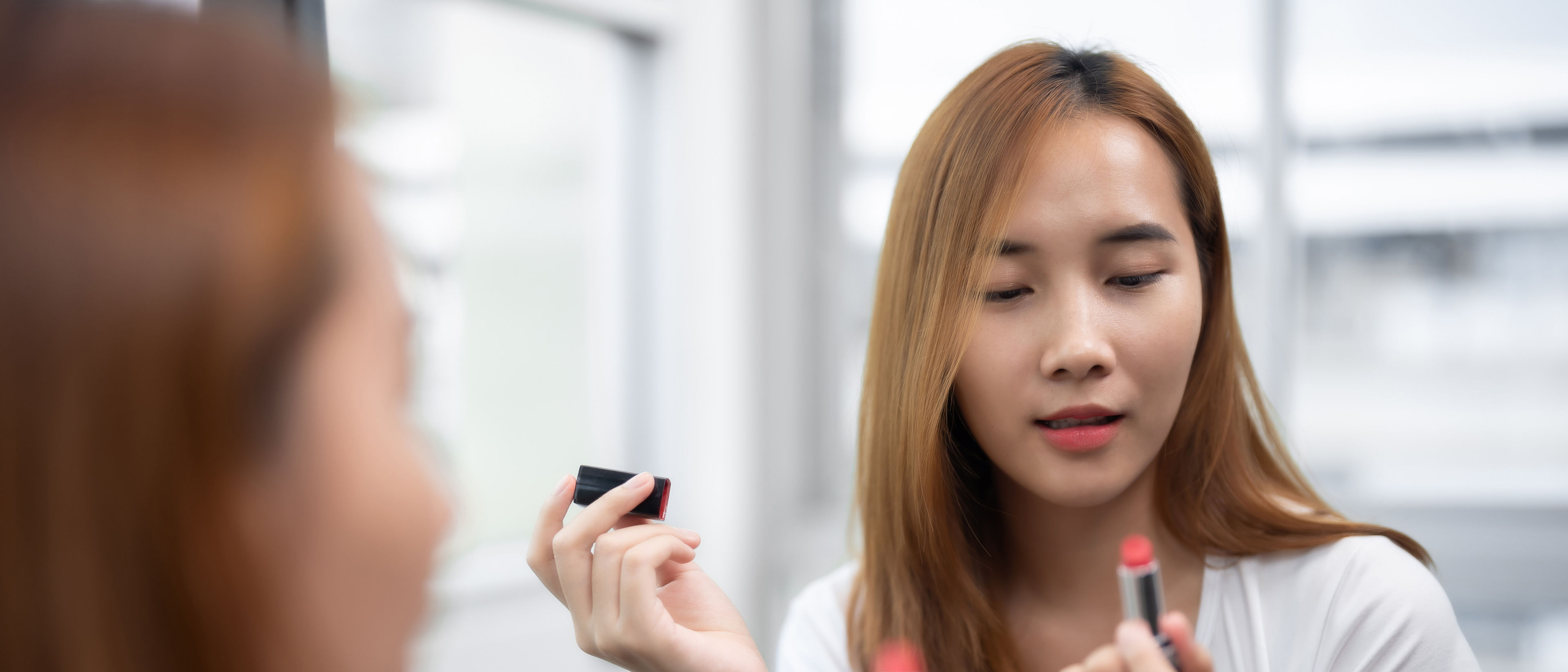 Woman applying lip balm