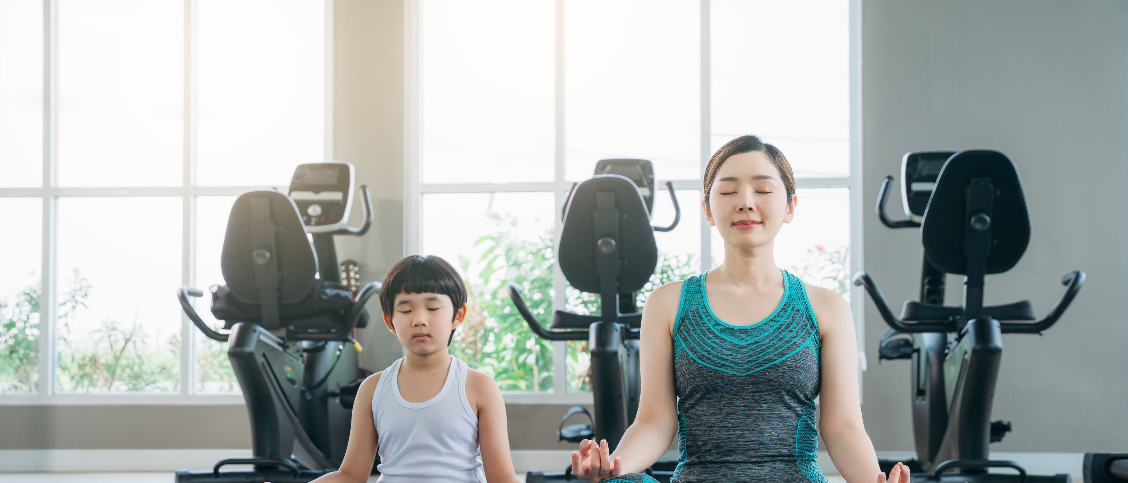 A mother and a child doing yoga