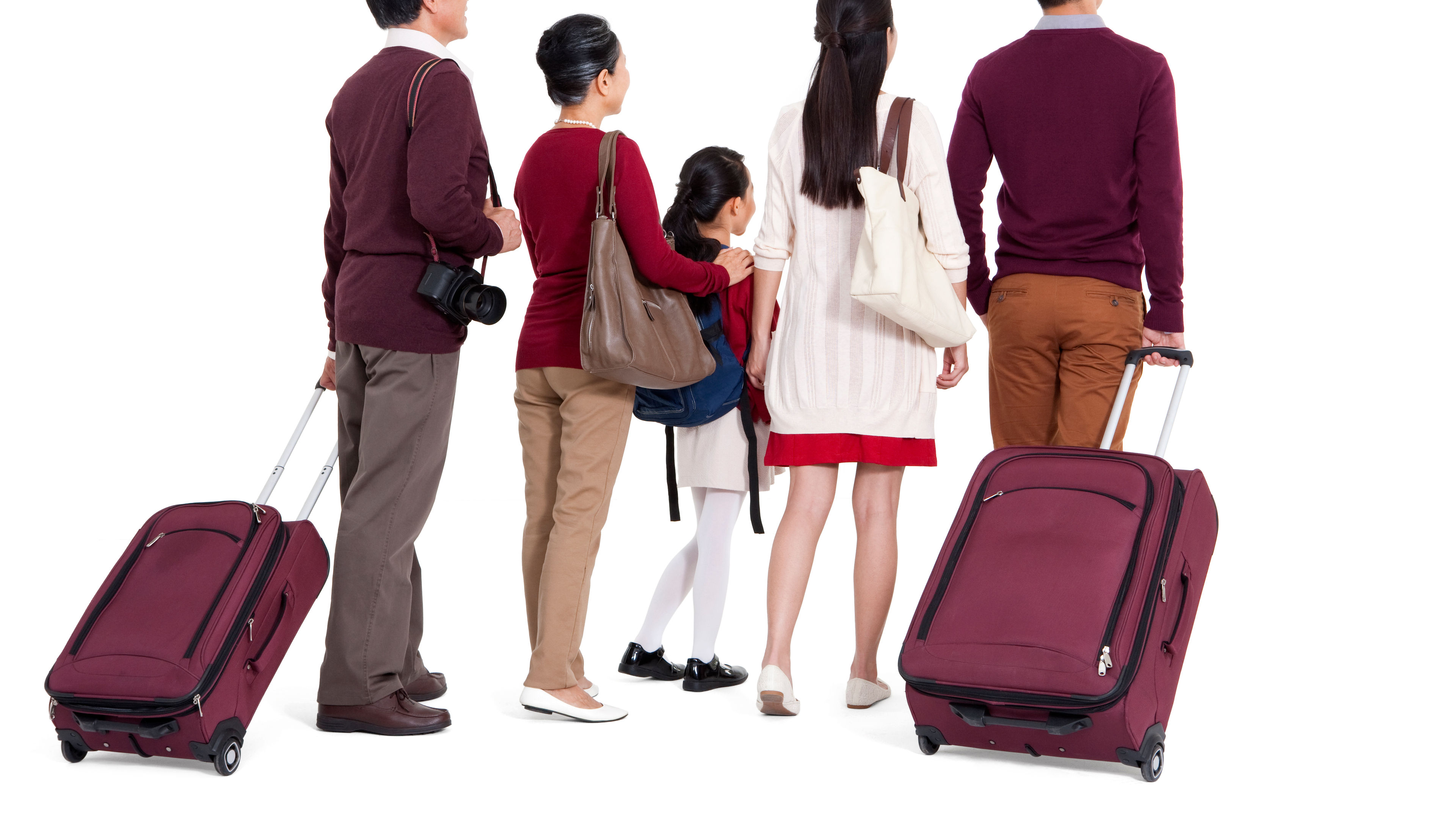 Family travelling together with luggage, dressed in coordinated outfits, ready for their journey