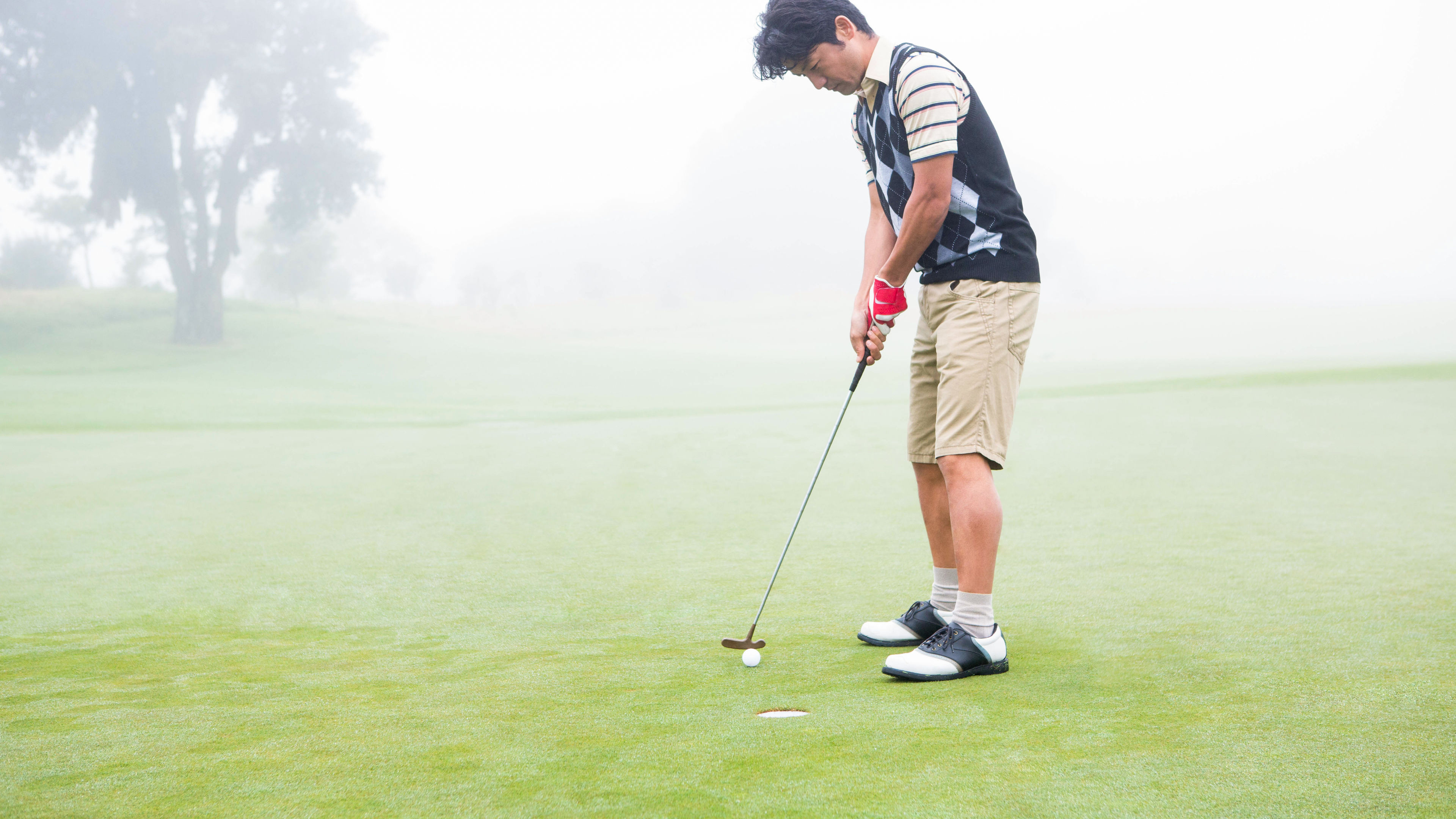 Man playing golf.