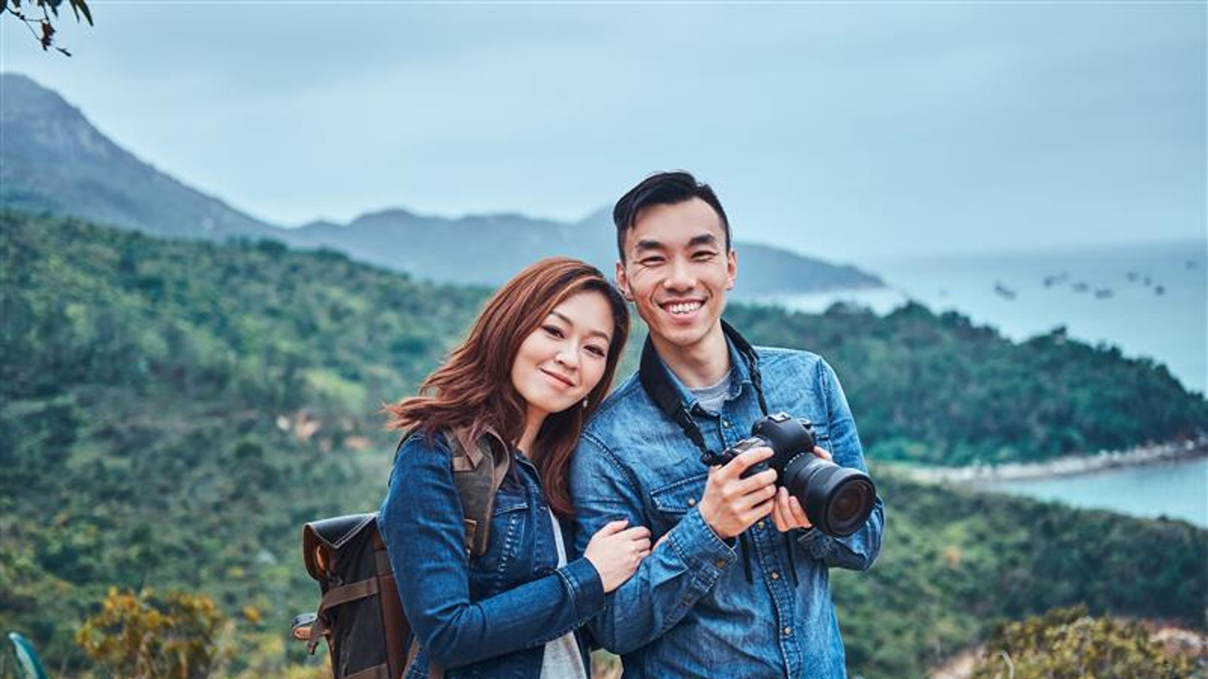 Young couple with camera on a hike 