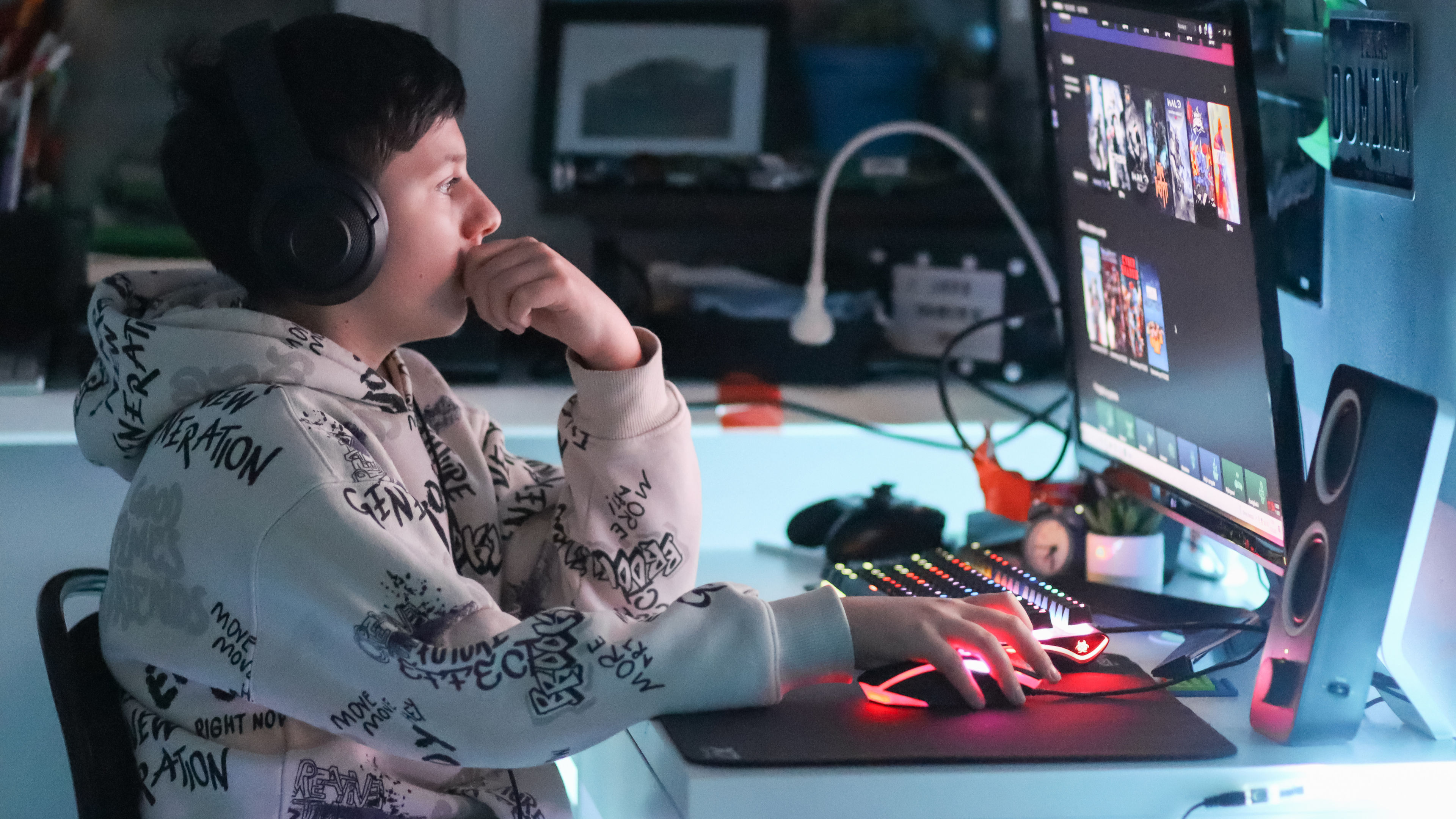 A teenage gamer playing on his computer.