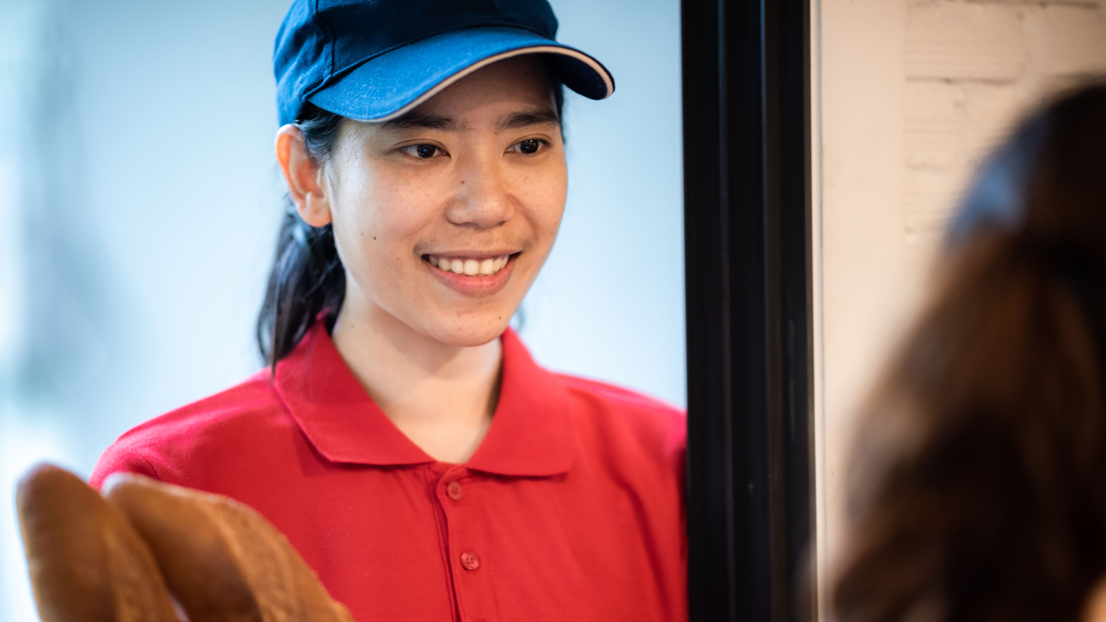 A young delivery woman. 