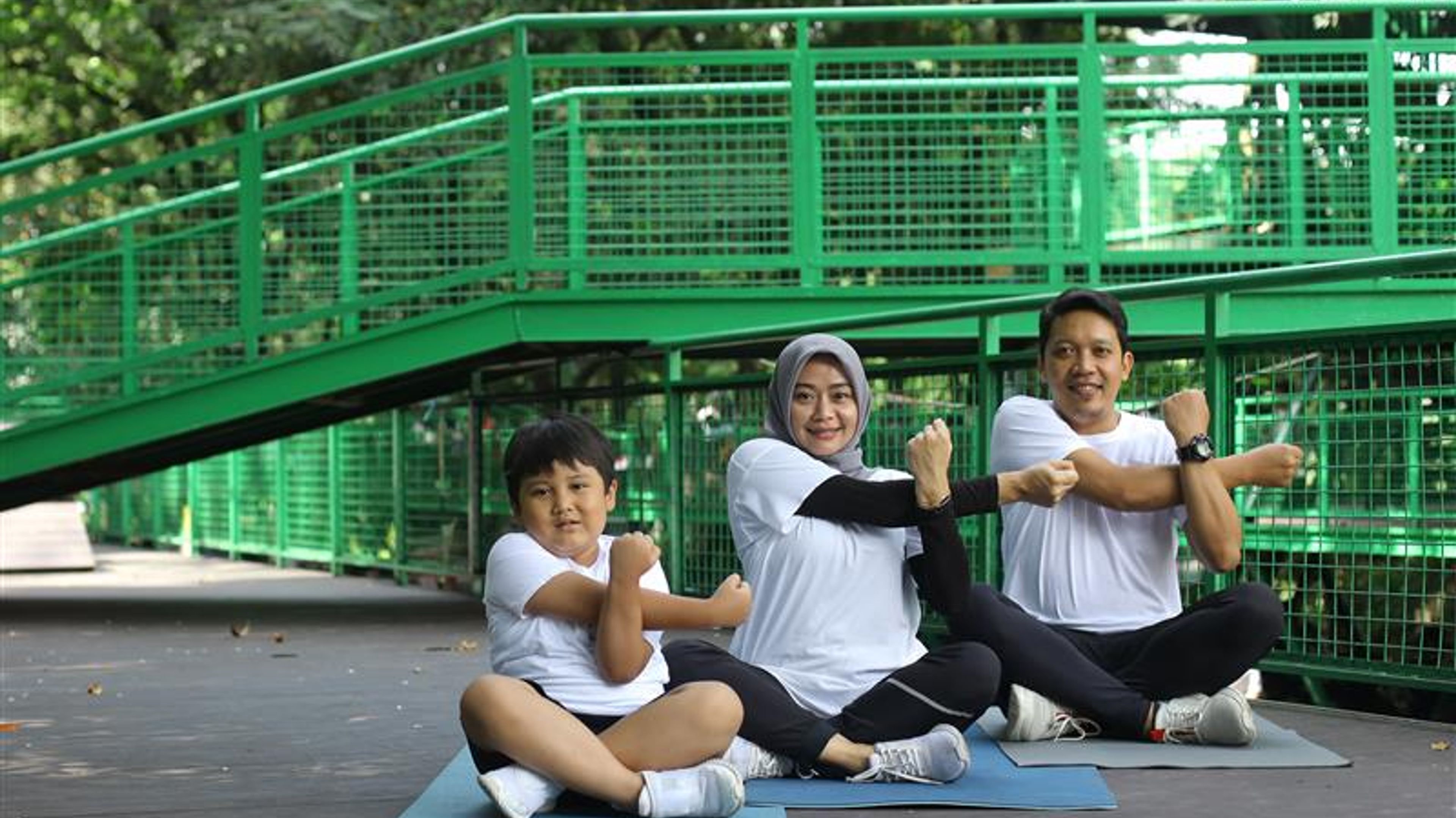 A family of three doing yoga 