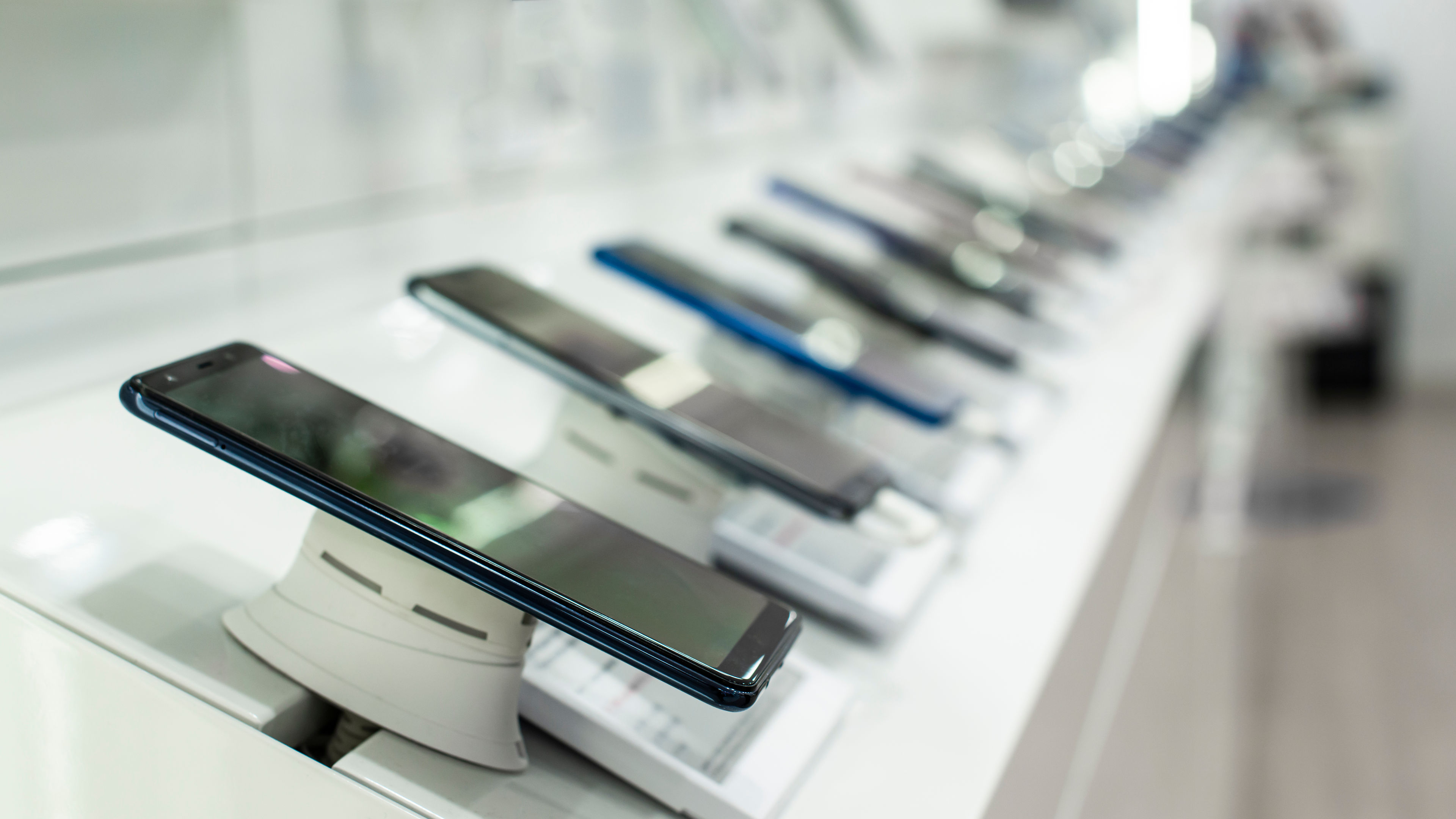 A row of mobile phones in a shop 