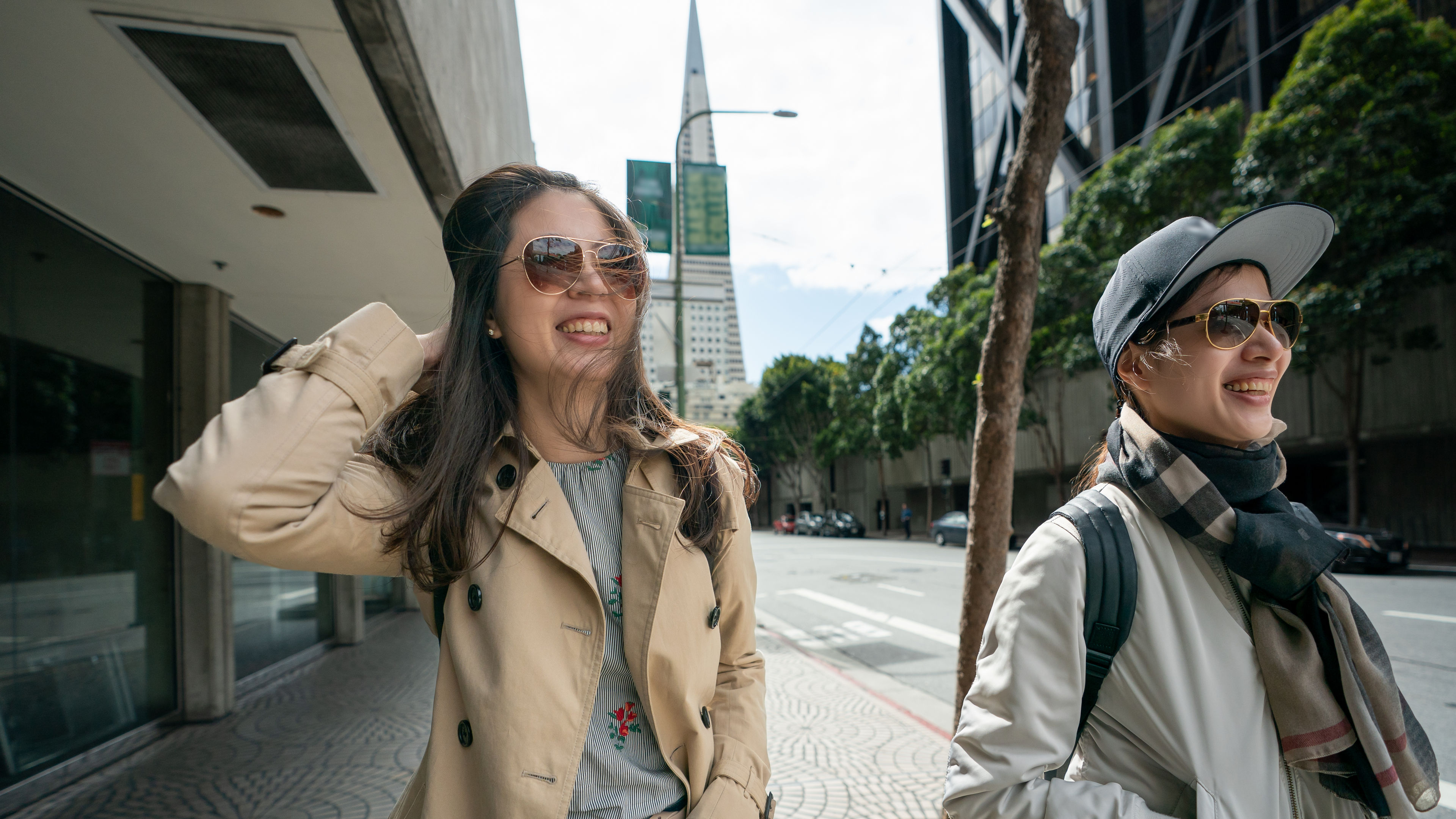 businesswoman walking with colleague on street. 