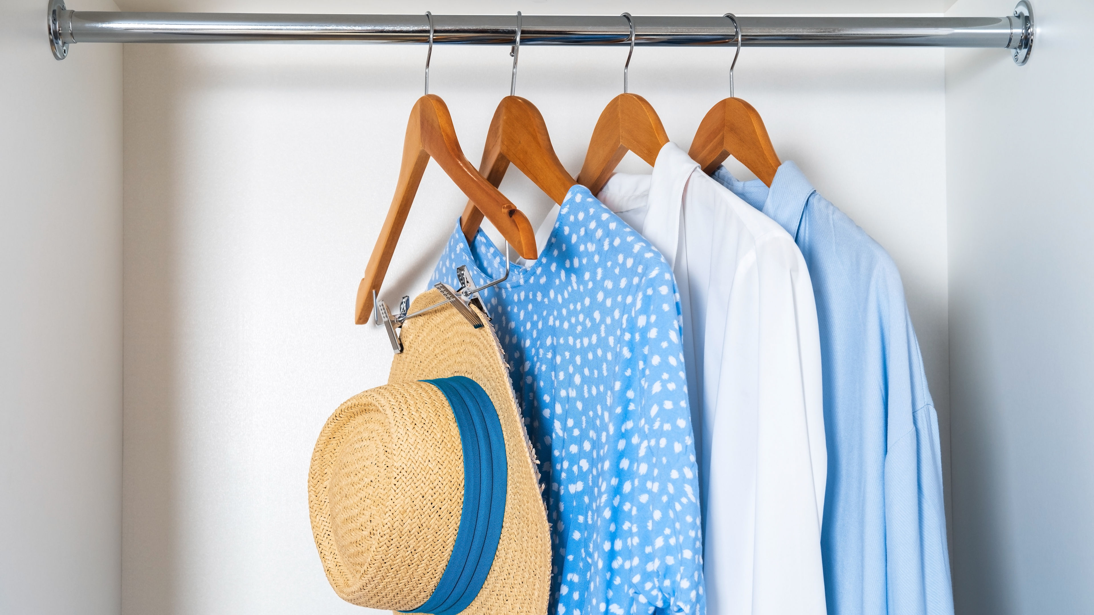 Cotton dress with a hat hanging in a cupboard 