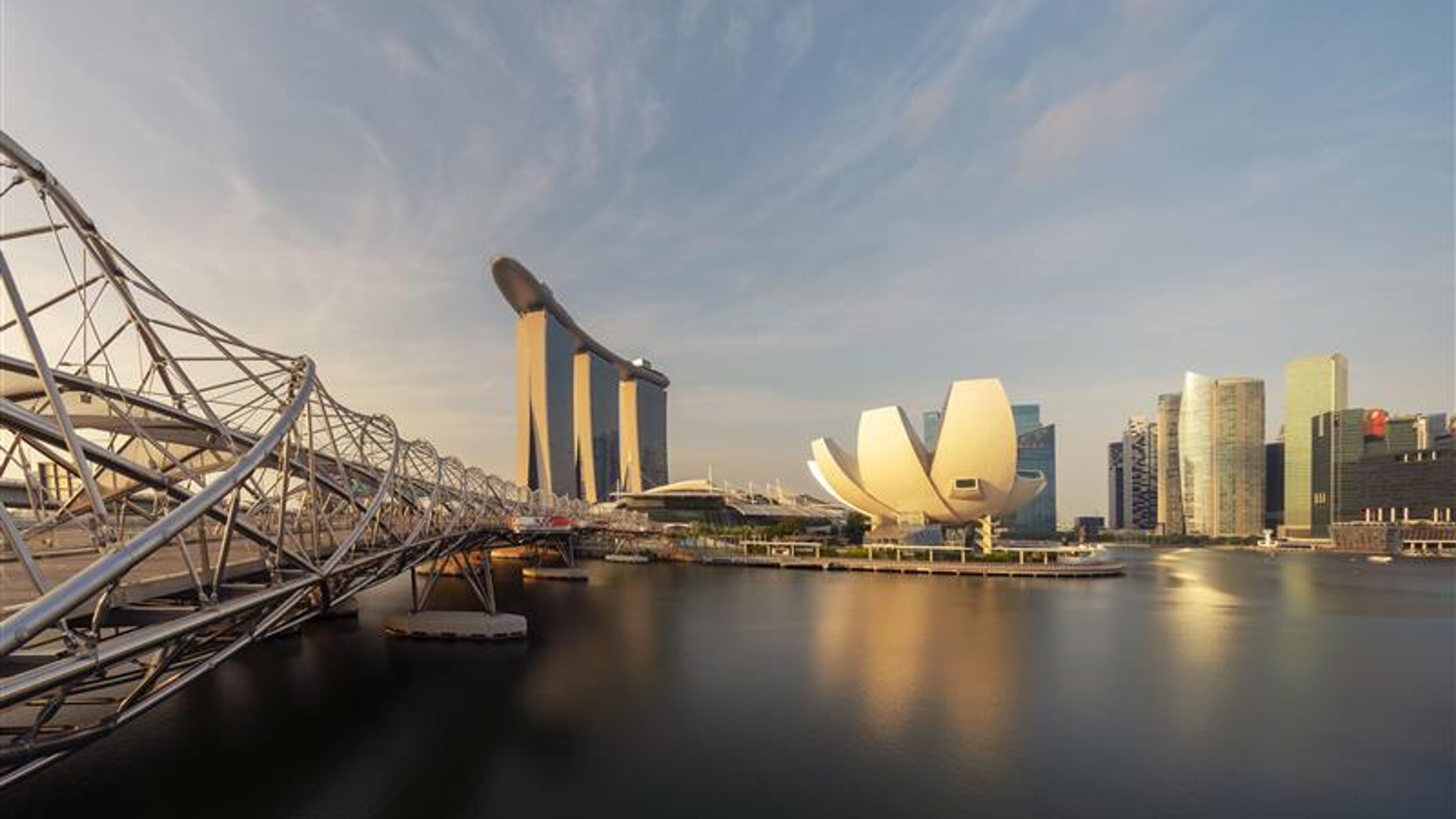 Downtown Singapore city in Marina Bay area at sunrise. Financial district and skyscraper buildings.