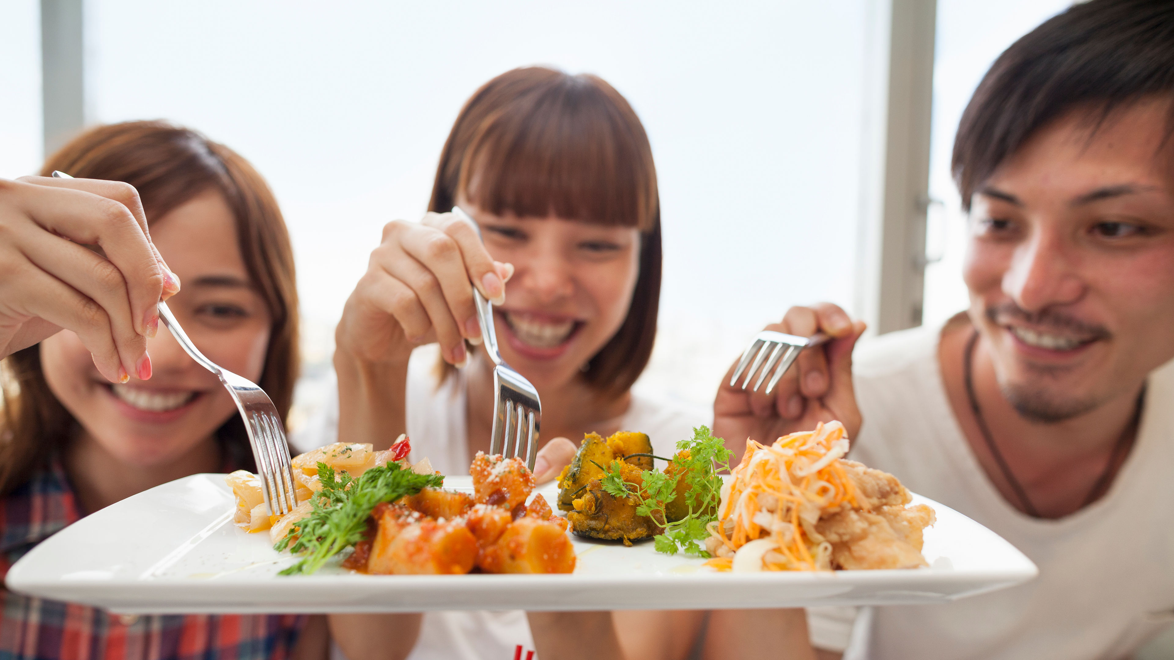 Group of friends sharing their food together