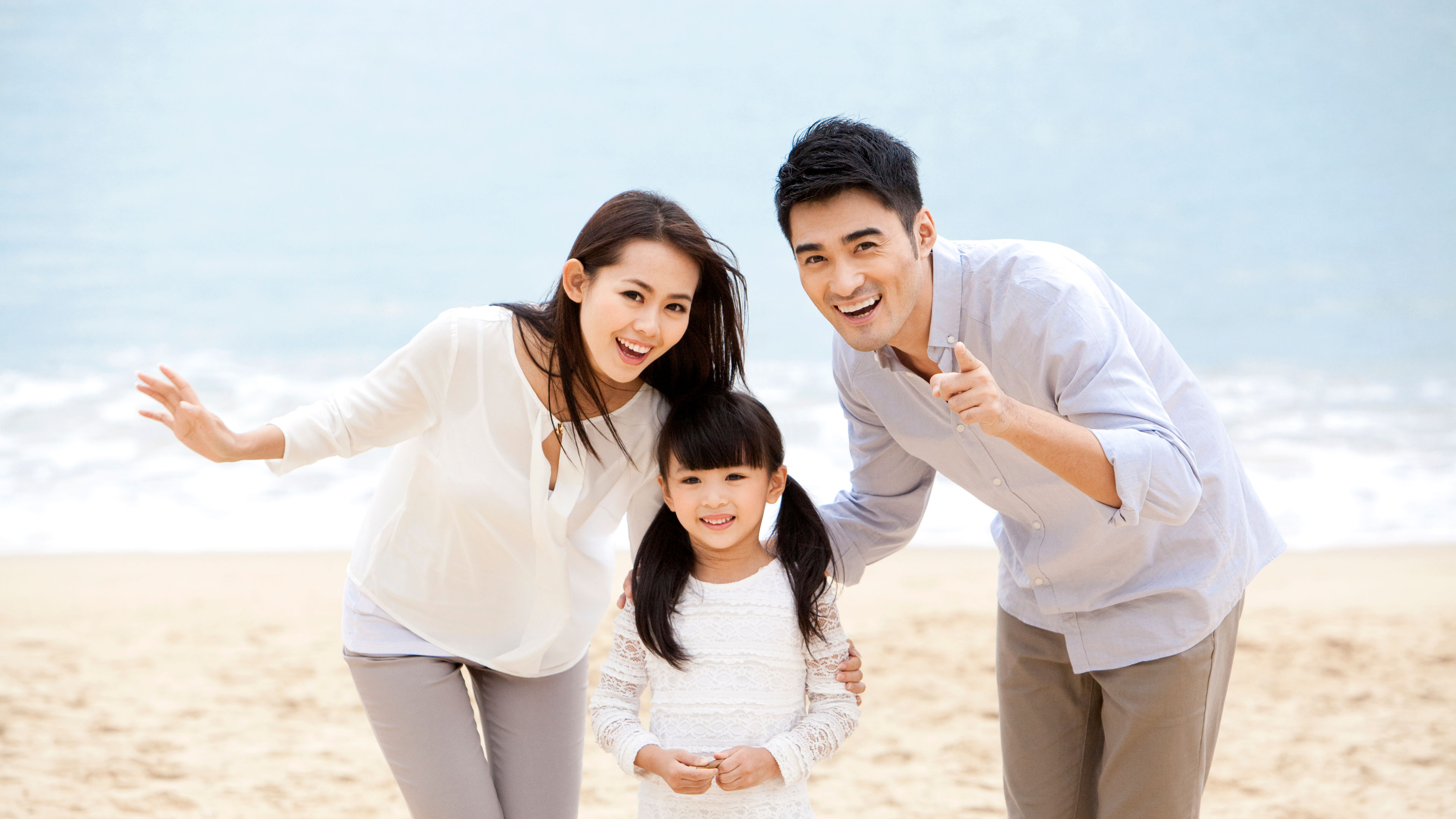 Happy family having a good time on the beach 