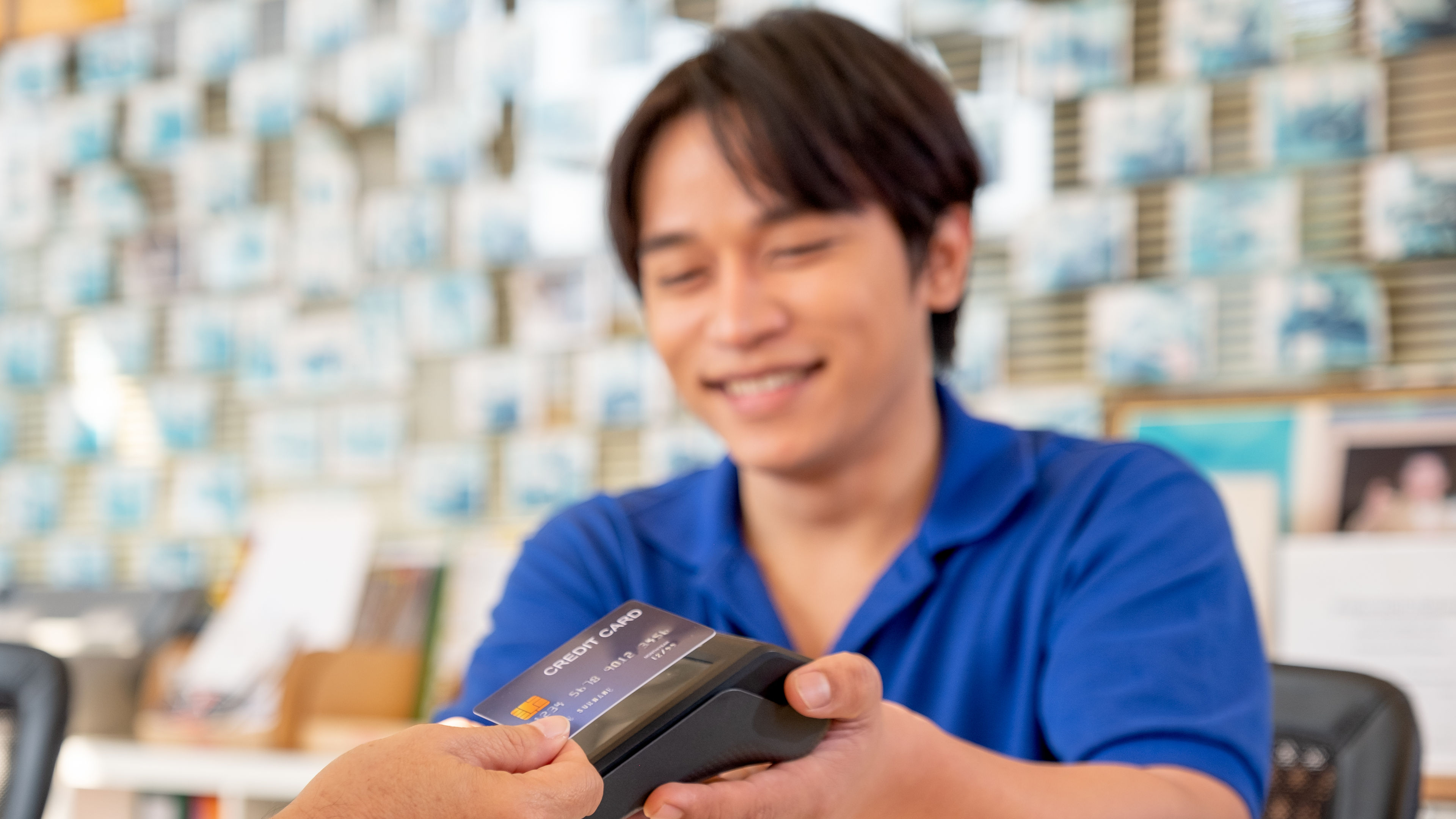 Main focus on credit card of Asian worker or staff at office reception credit card.
