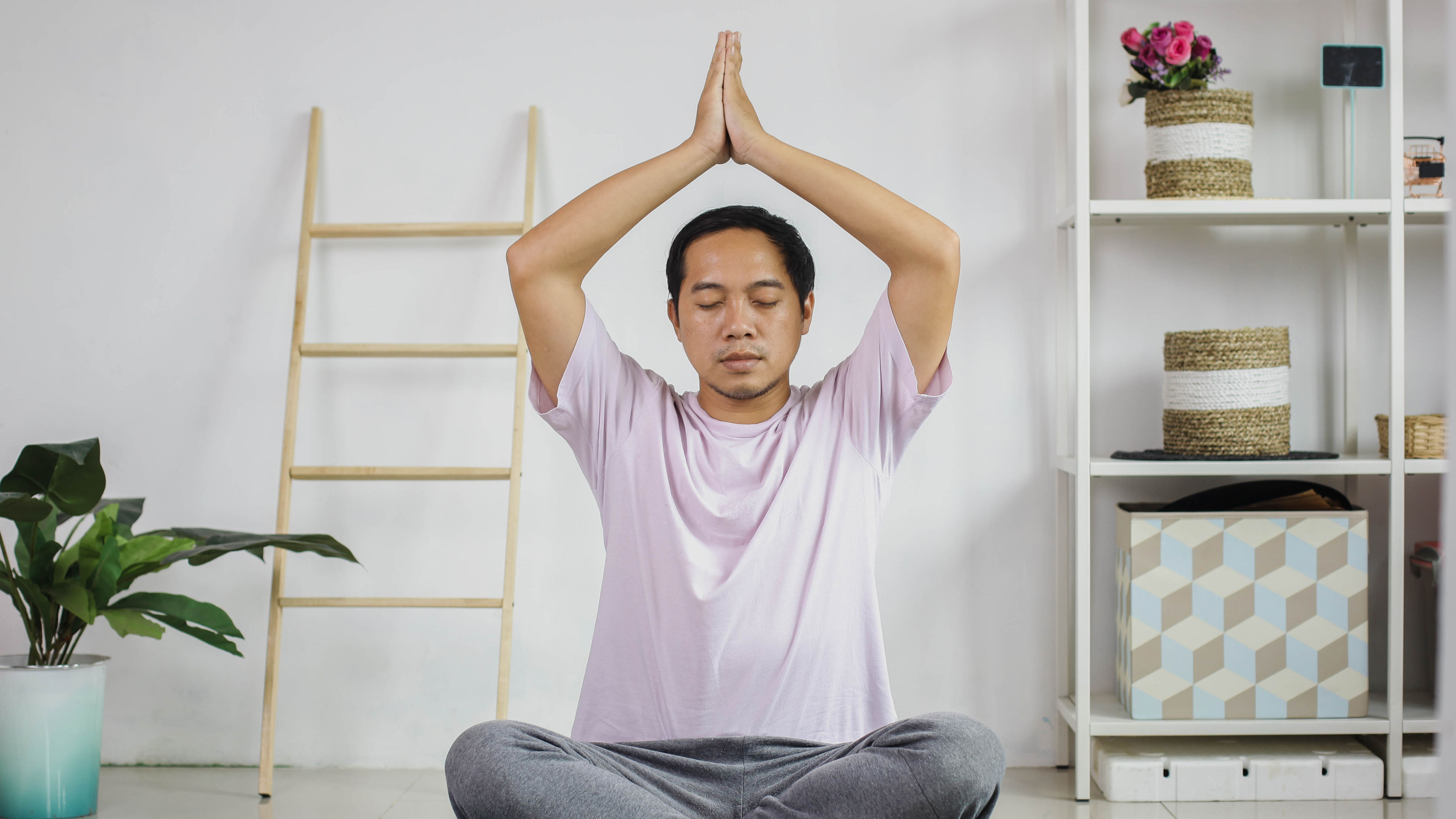 Man meditating at home 