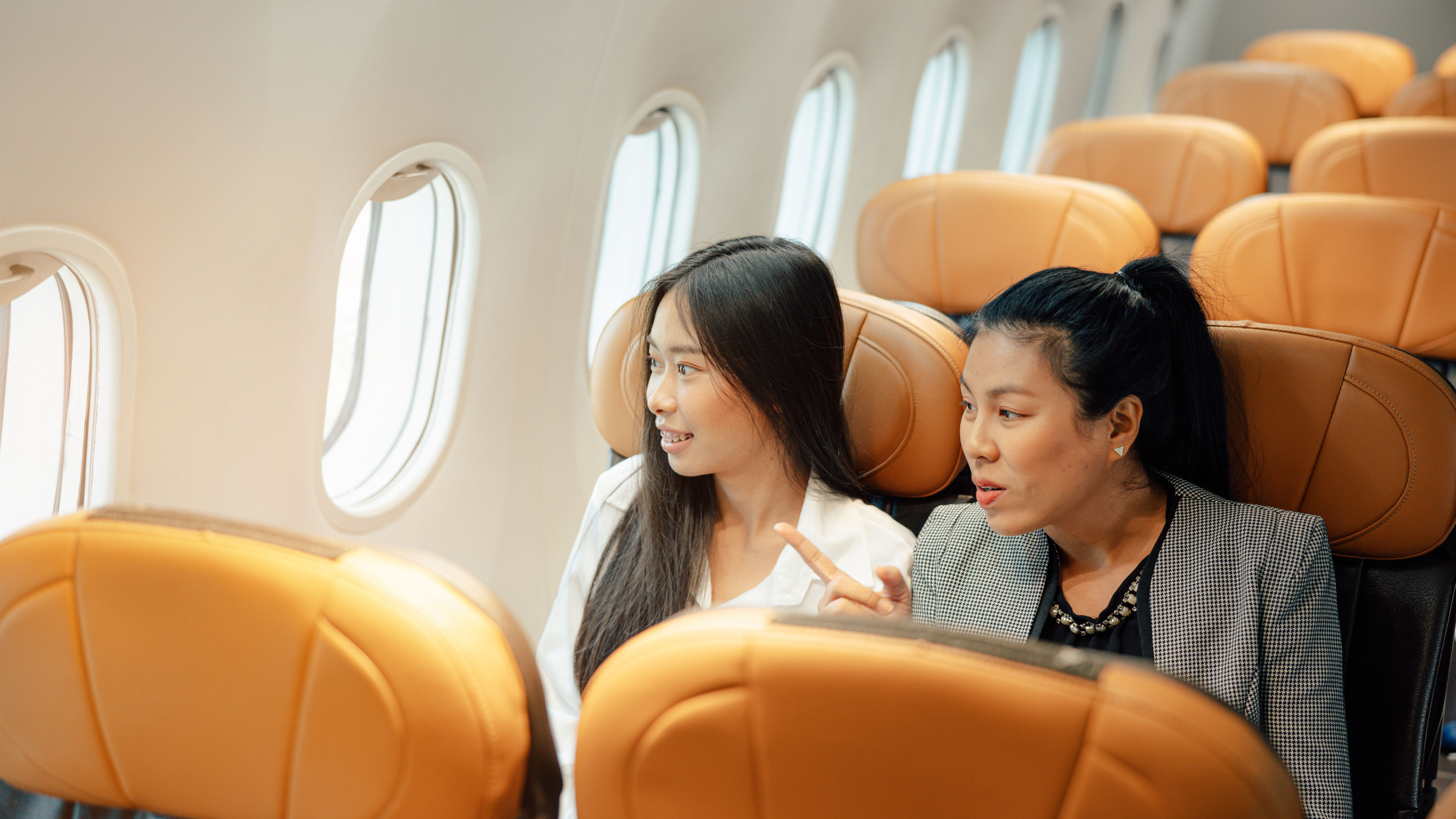 Smiling woman talking to passenger 