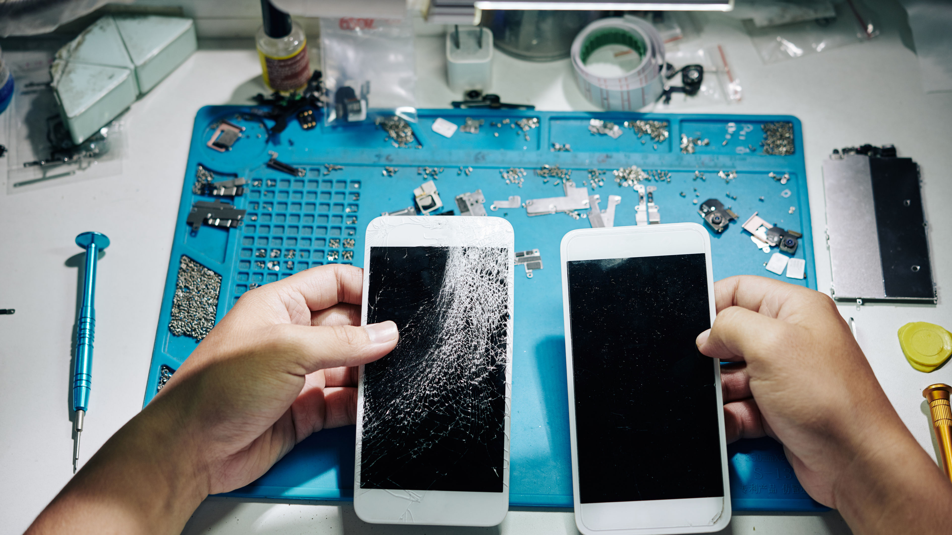 The repairman changing smartphone screen. 