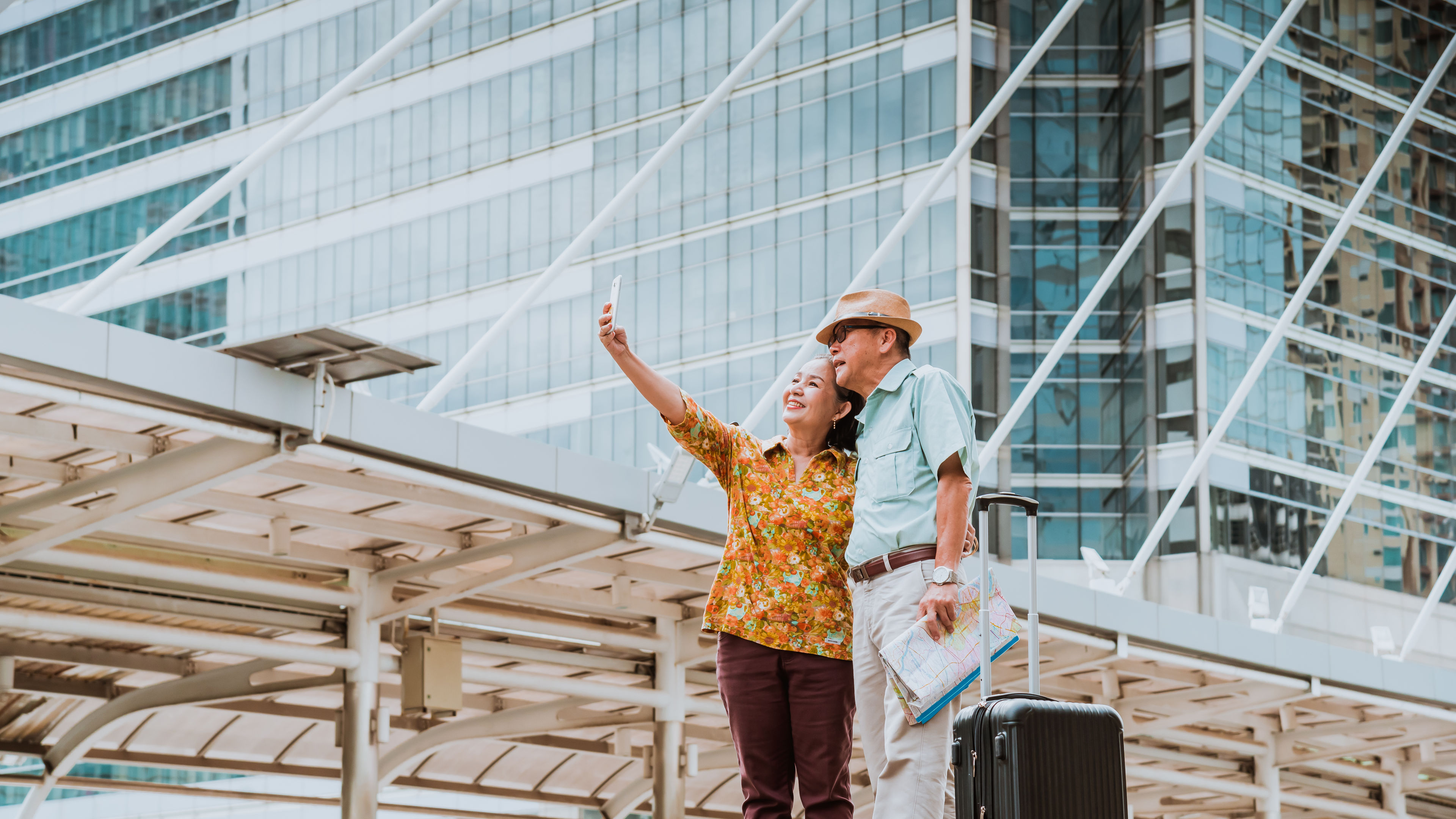 Tourist woman and oldest man wearing casual dress ,hand holding baggage for travel walking and talking 