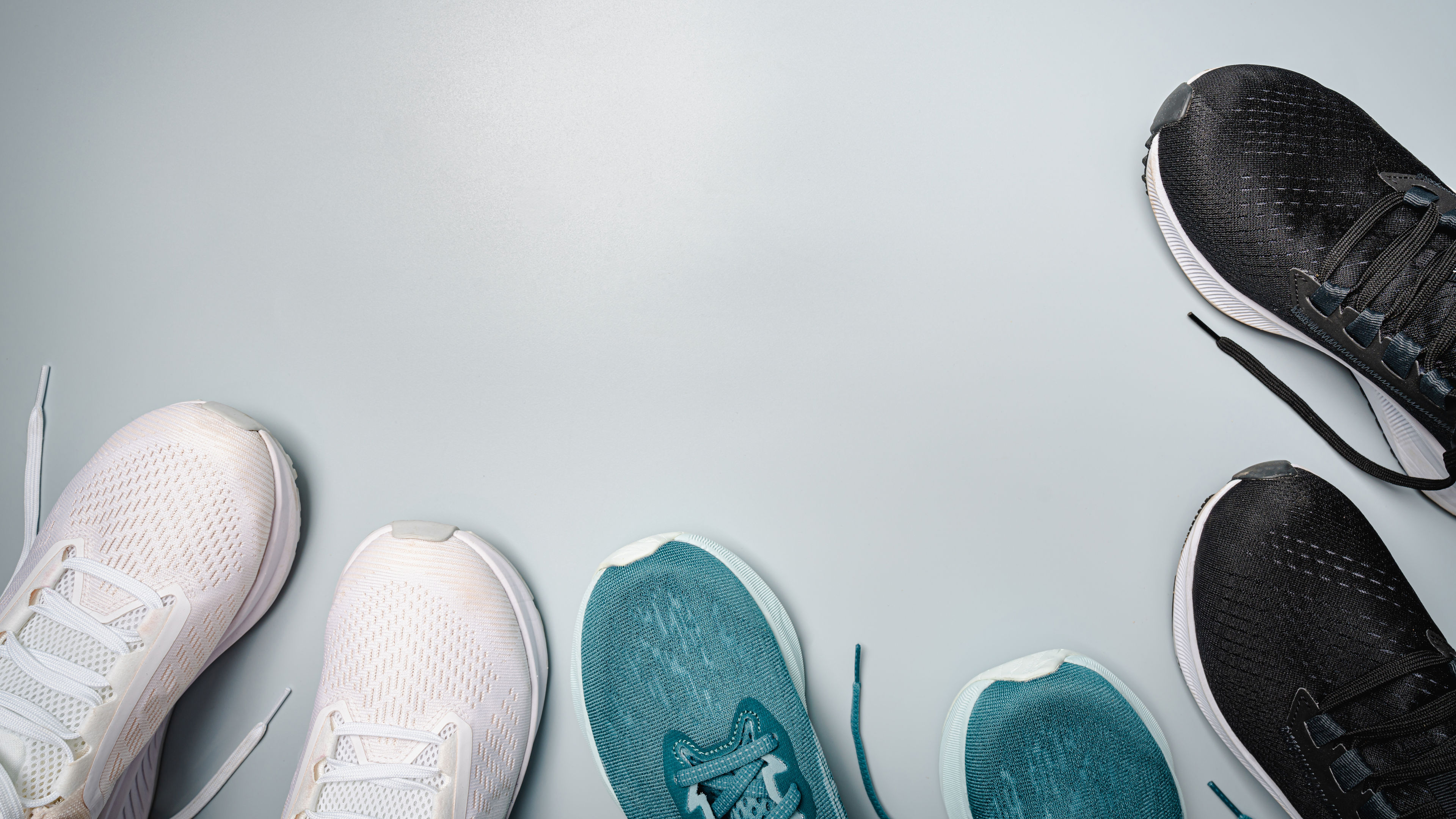 Workout flat-lay with sneakers on gray background top view