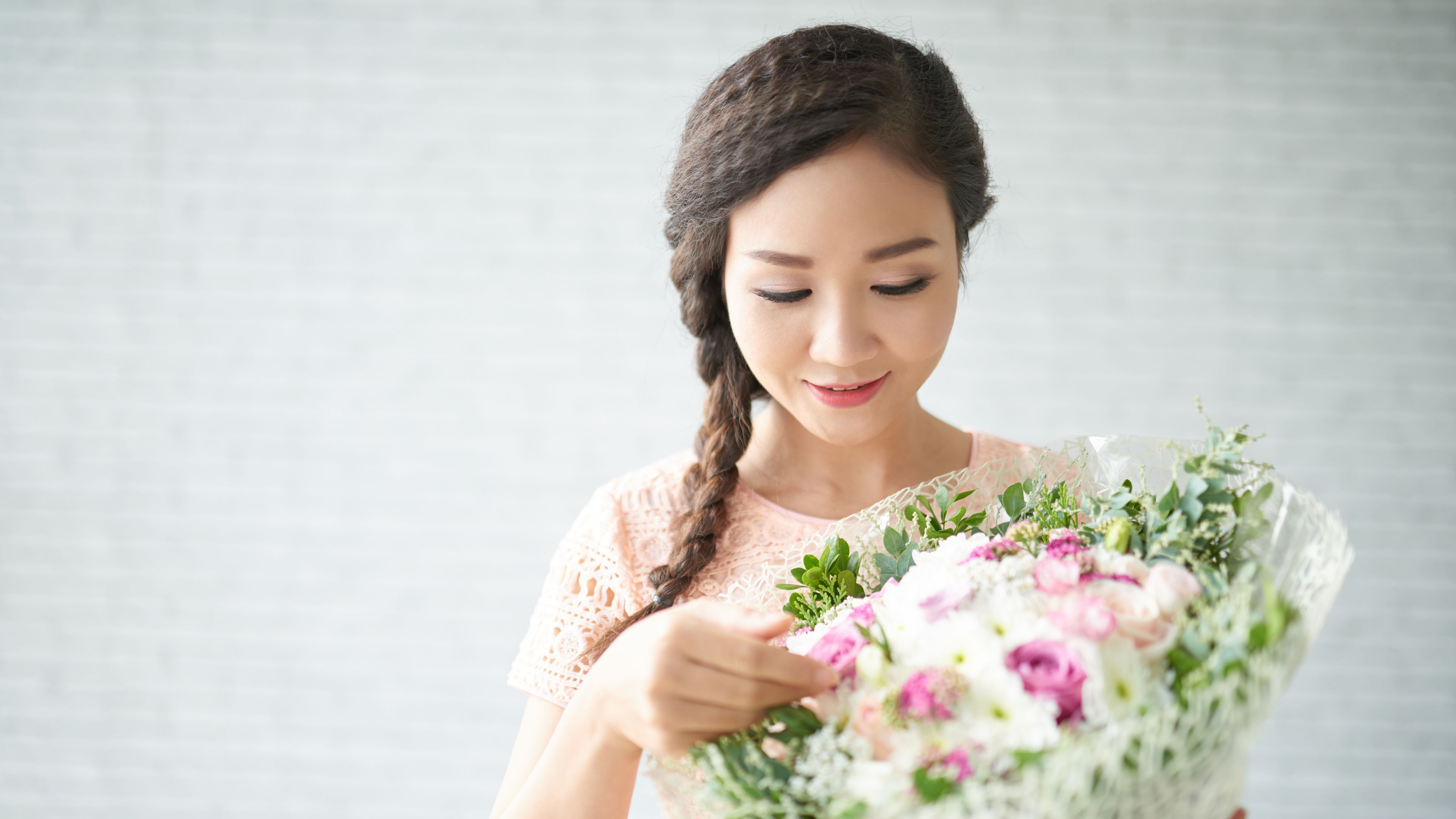 Image of a young woman with flowers in hands 