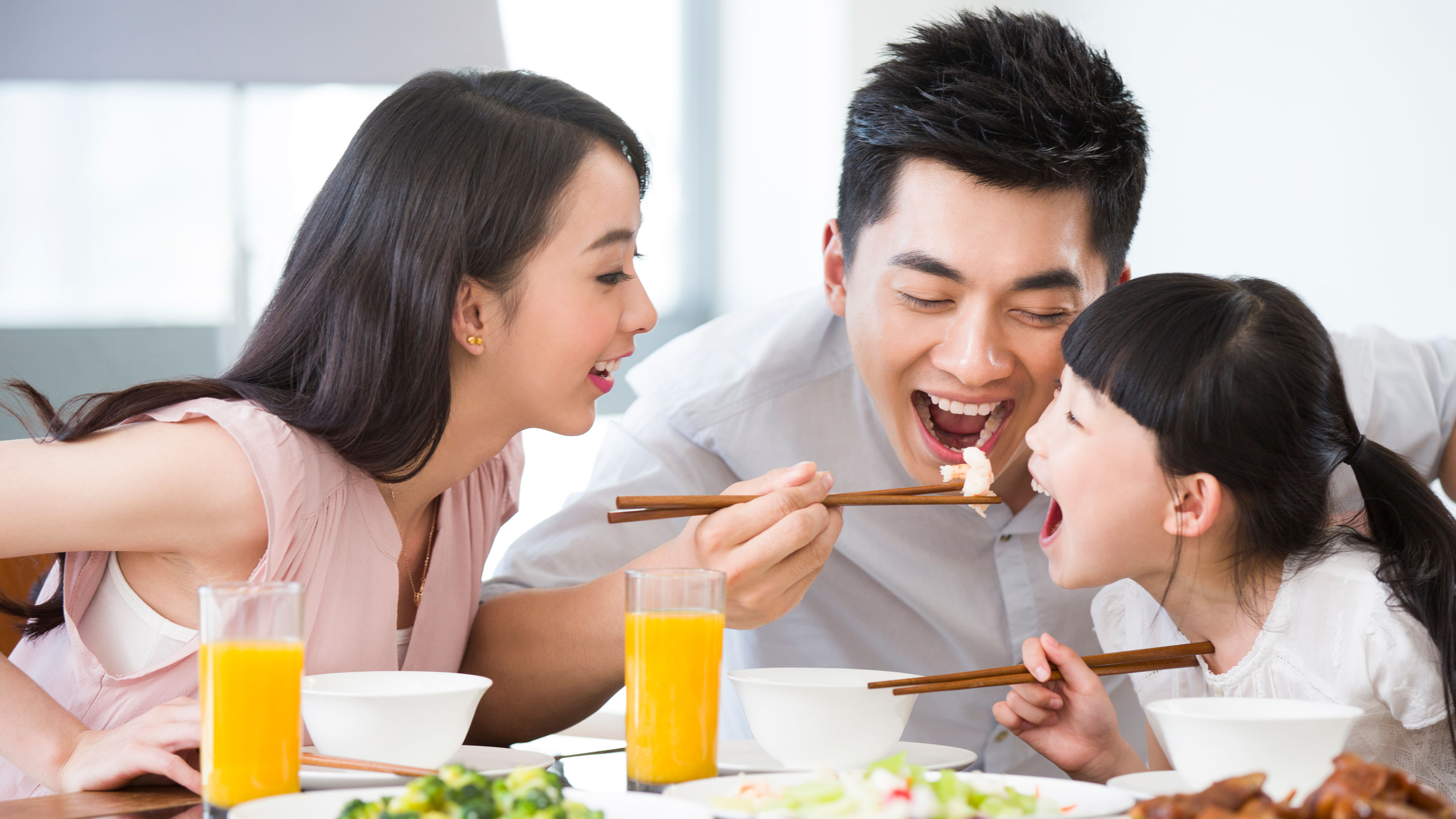 A family happily enjoys a delicious lunch at a restaurant.