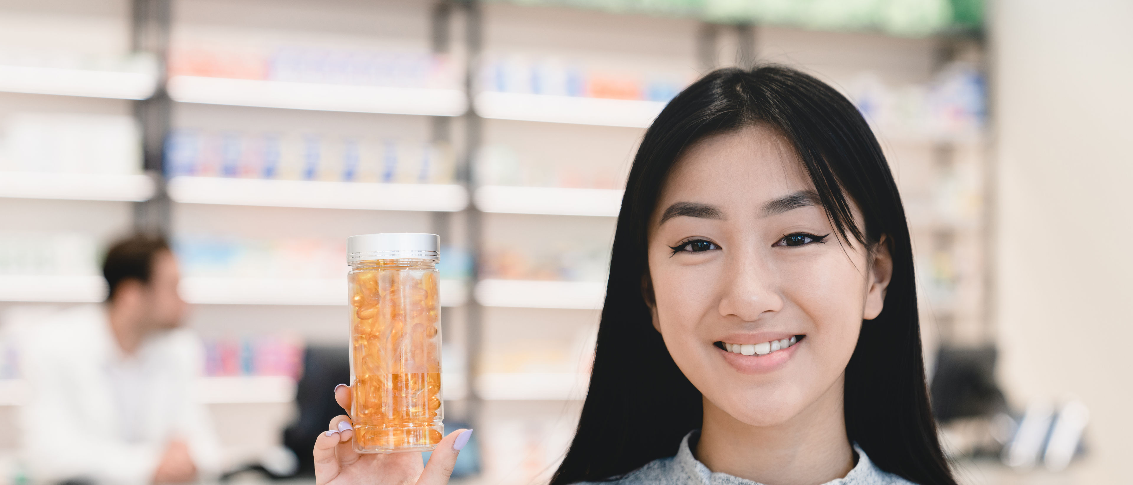 Woman holding a jar of pills