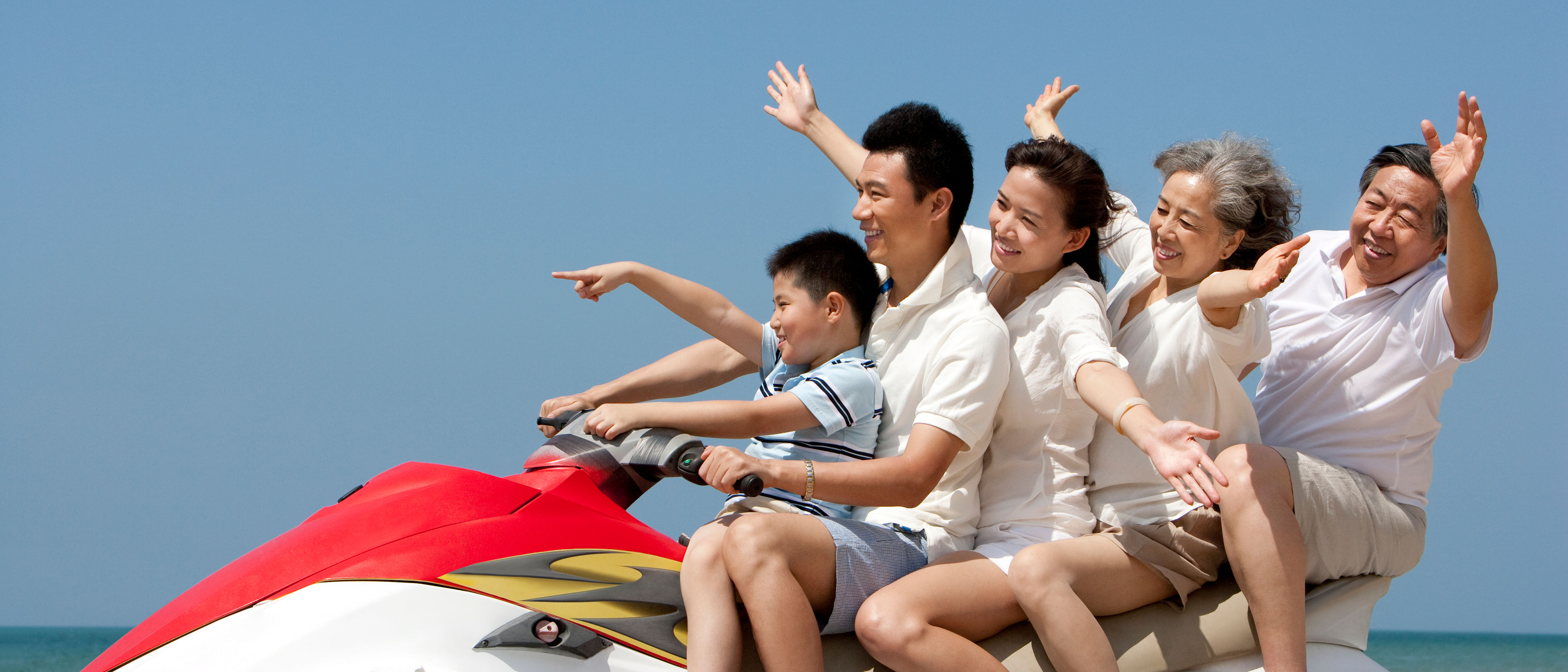 Happy family riding on a jet ski