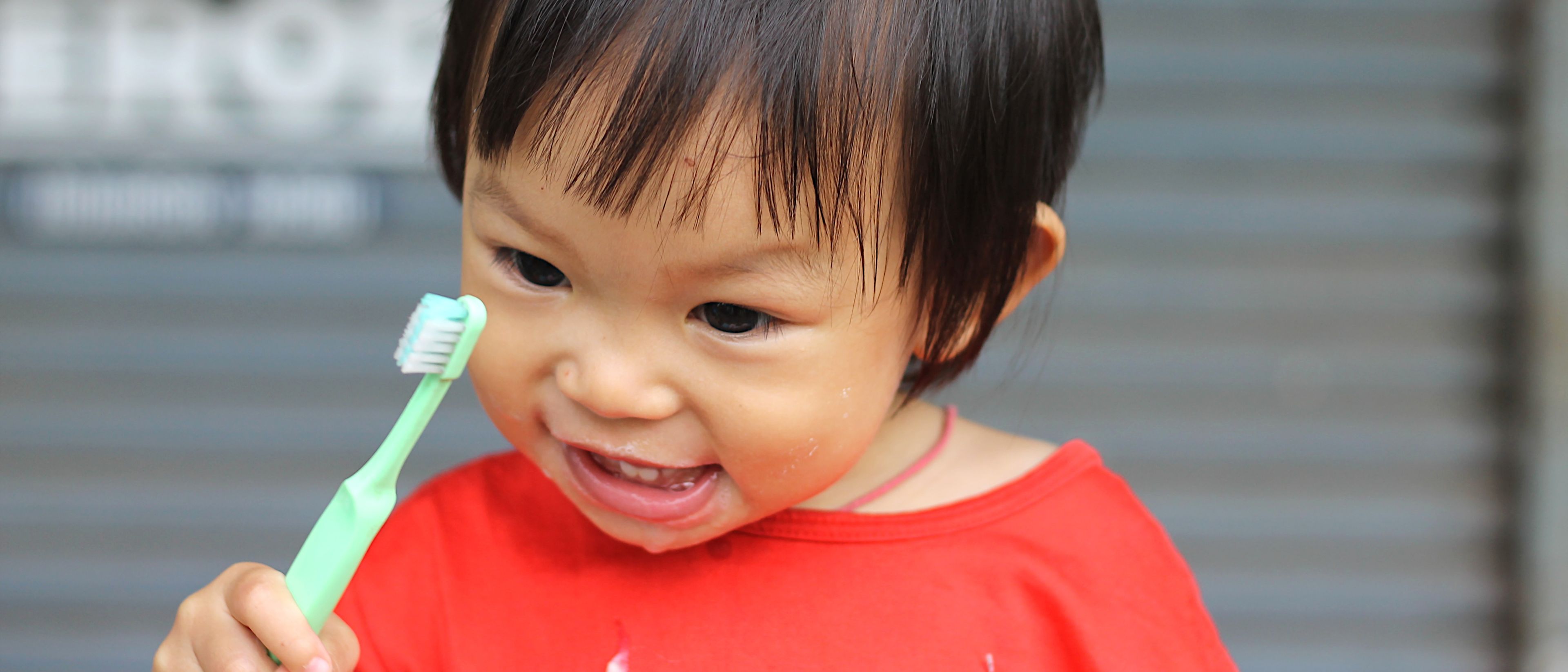 Happy girl brushing her teeth