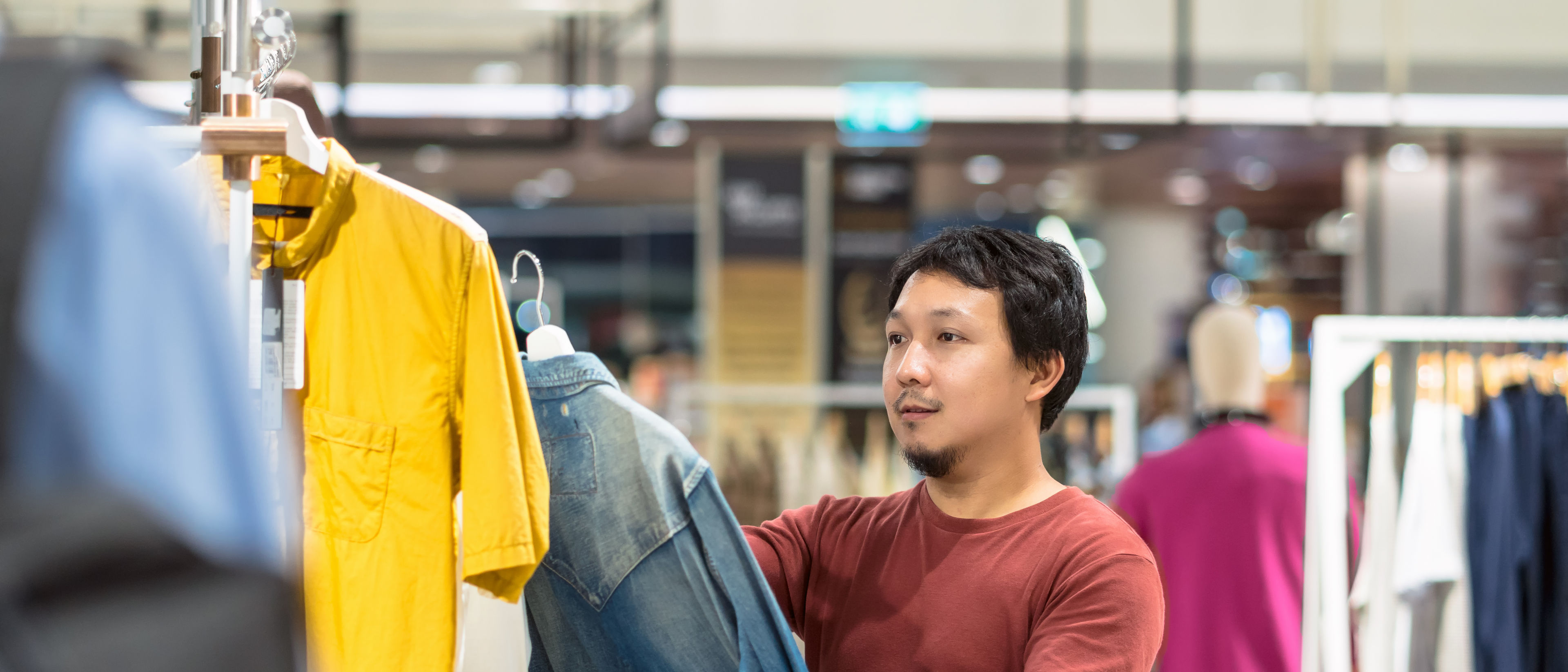 Man with beard choosing cloths