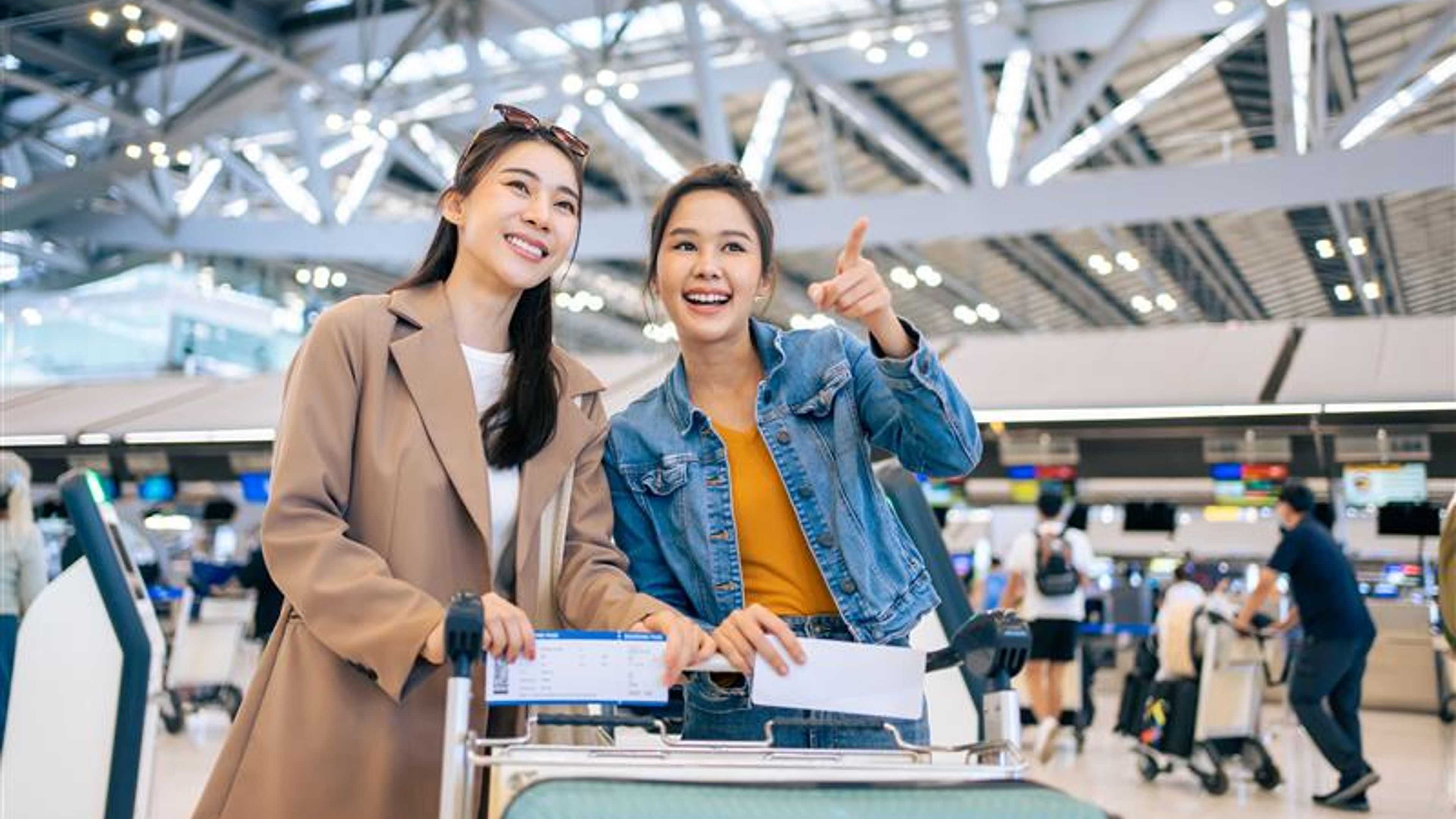 Two women at an airport. 