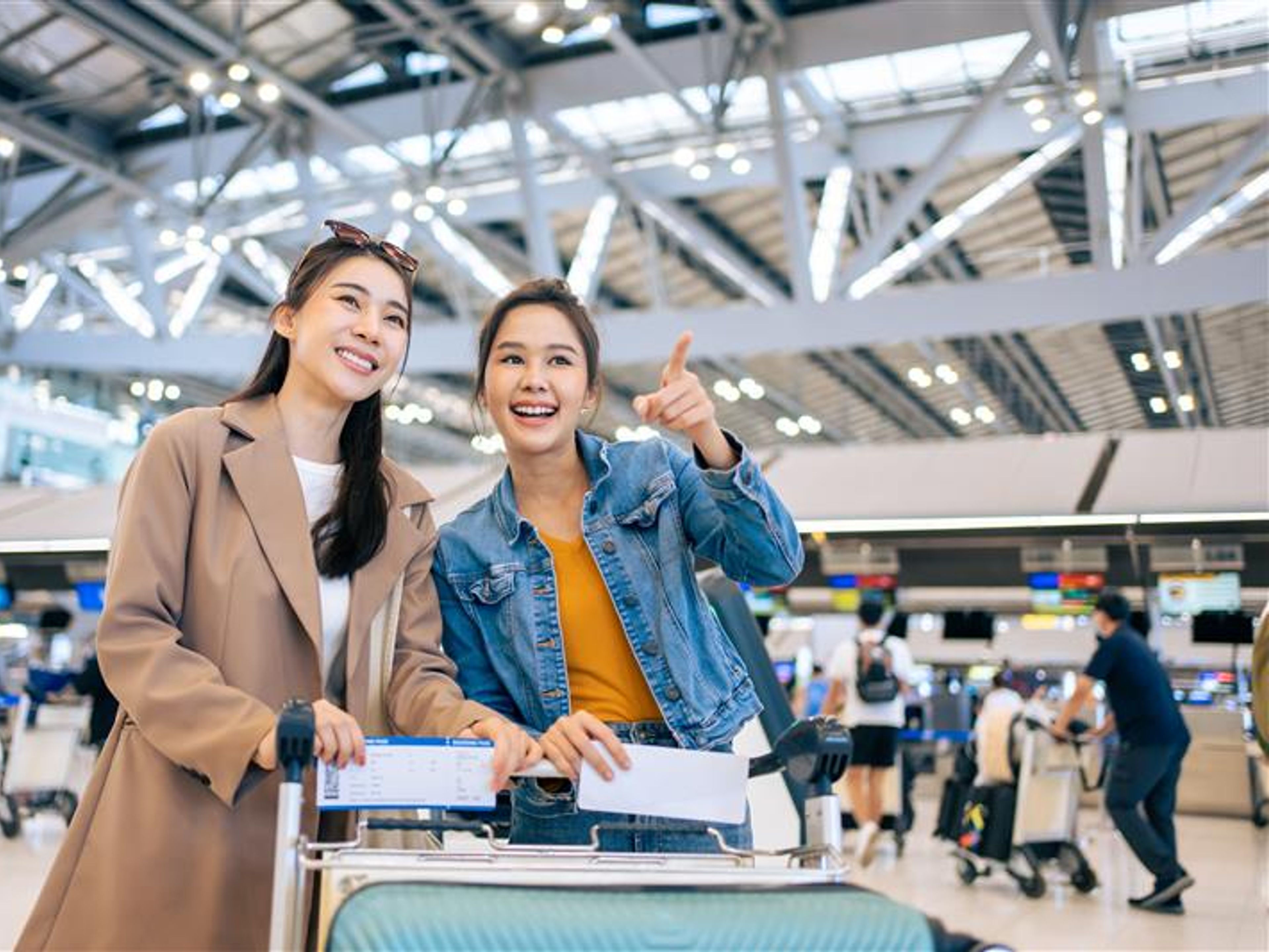 Two women at an airport. 