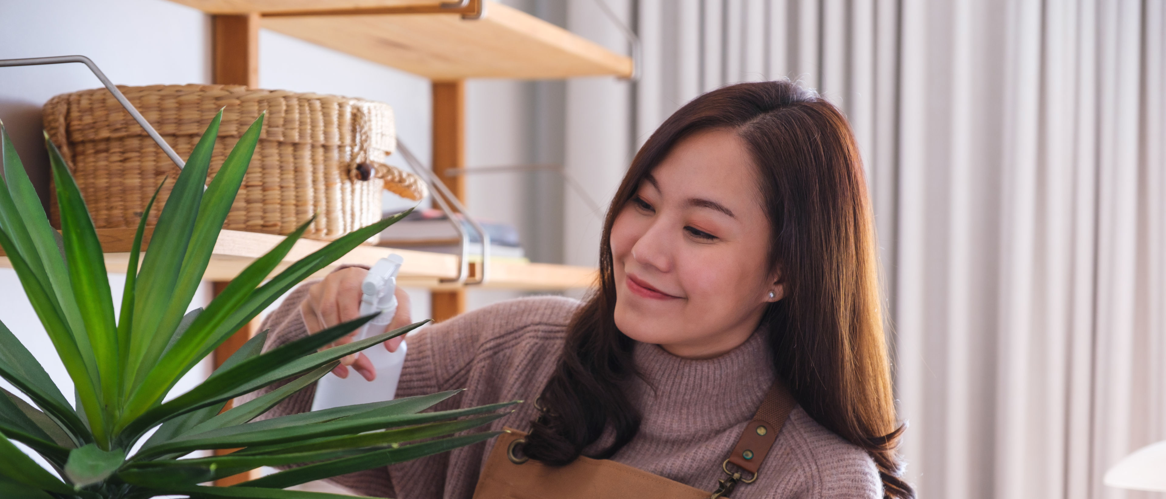 Young woman taking care of plants