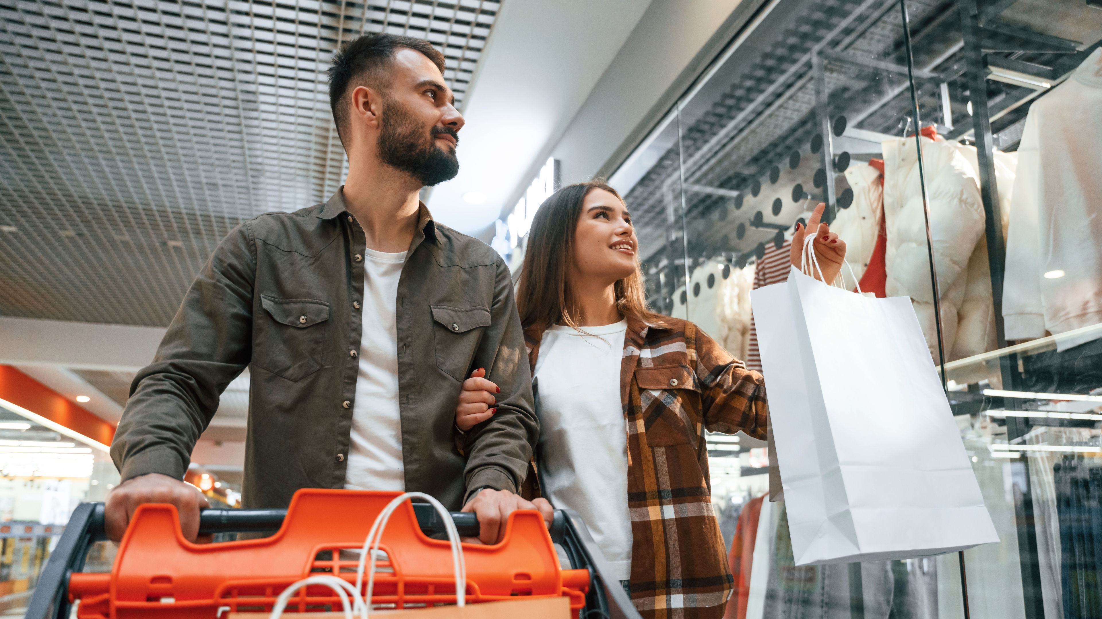 Young couple are in supermarket together.