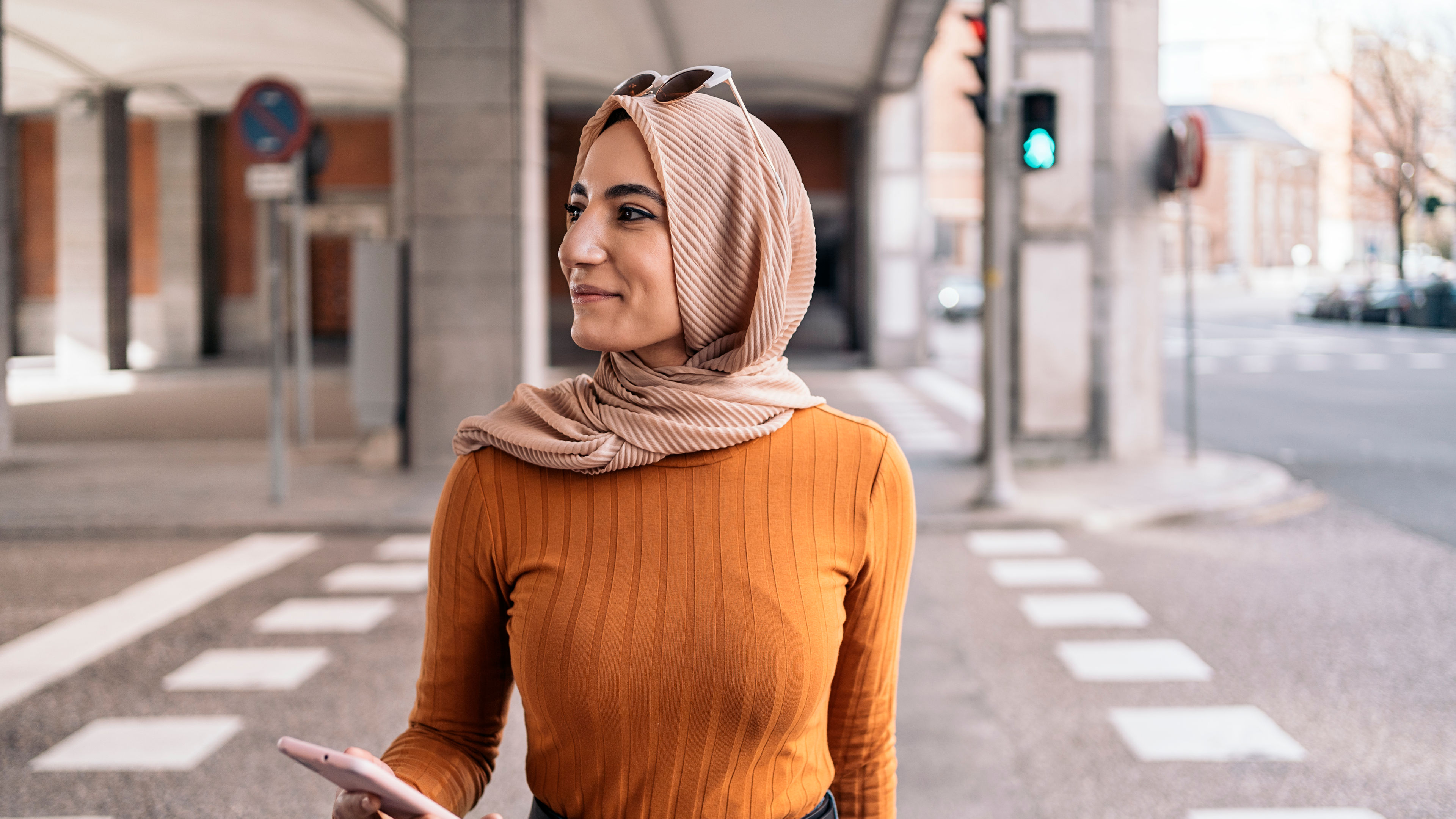 A woman wearing an orange top
