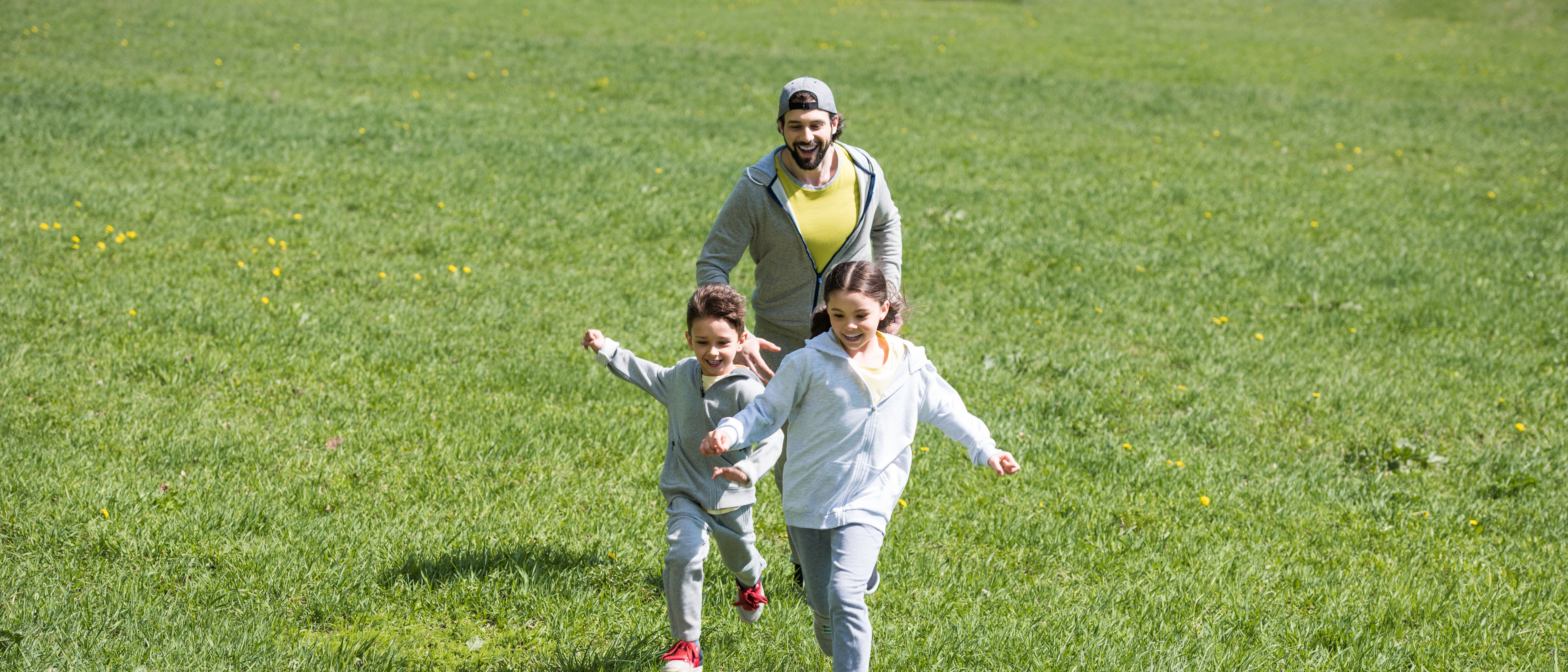 Father playing football with children