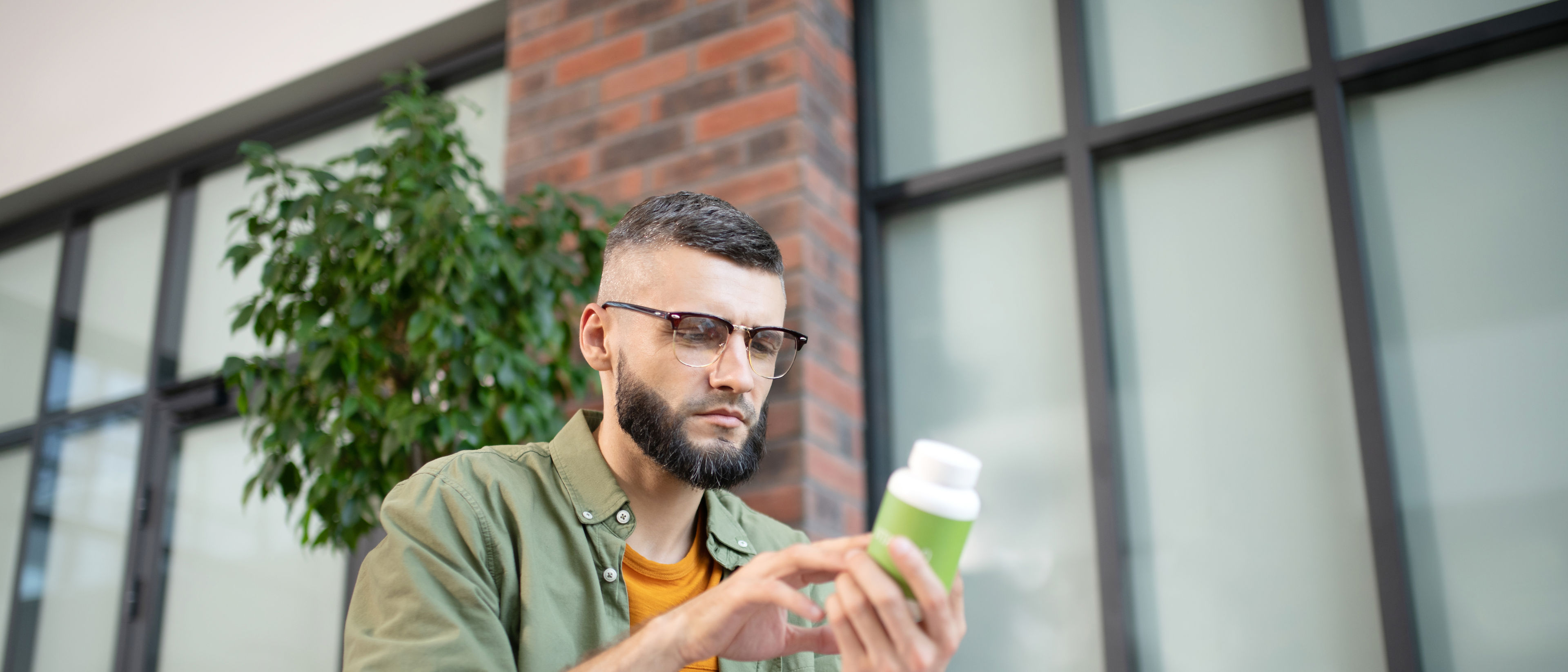 Man holding vitamin bottle