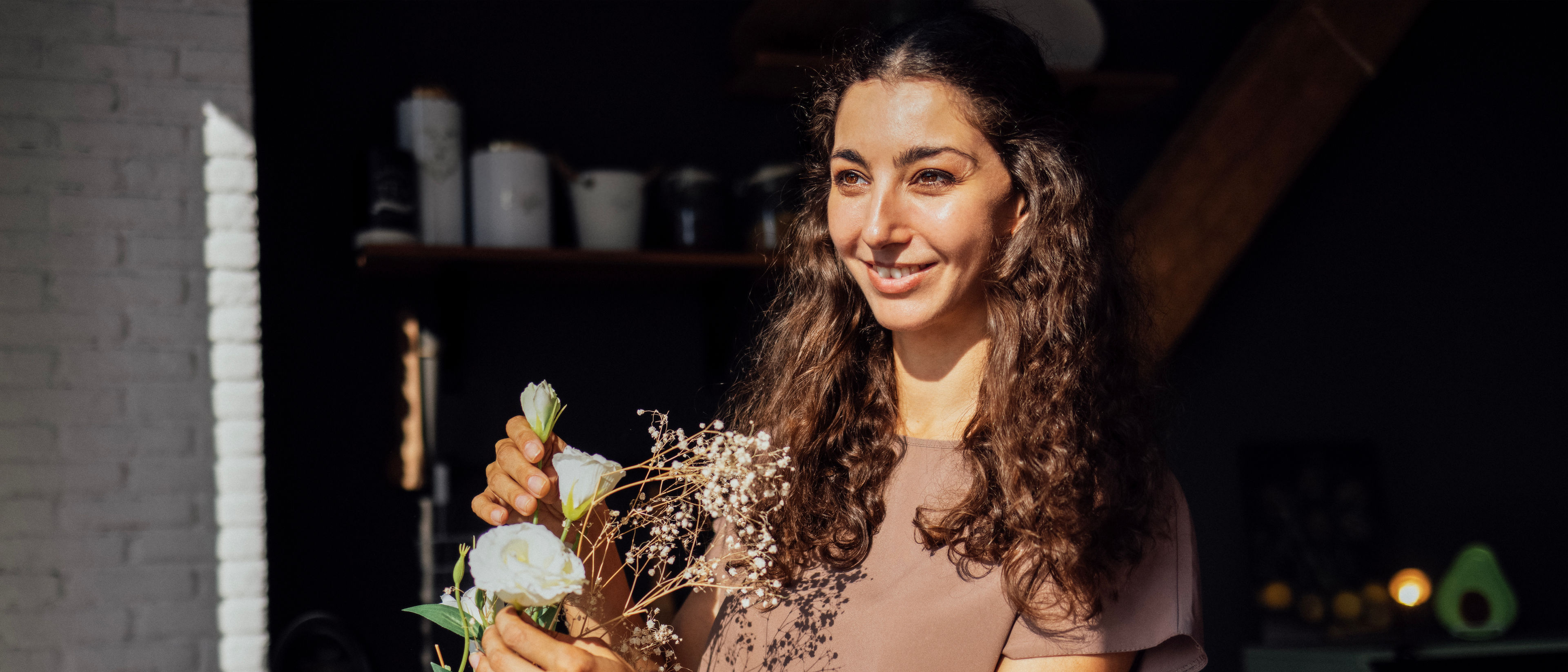 Woman putting flowers on a vase