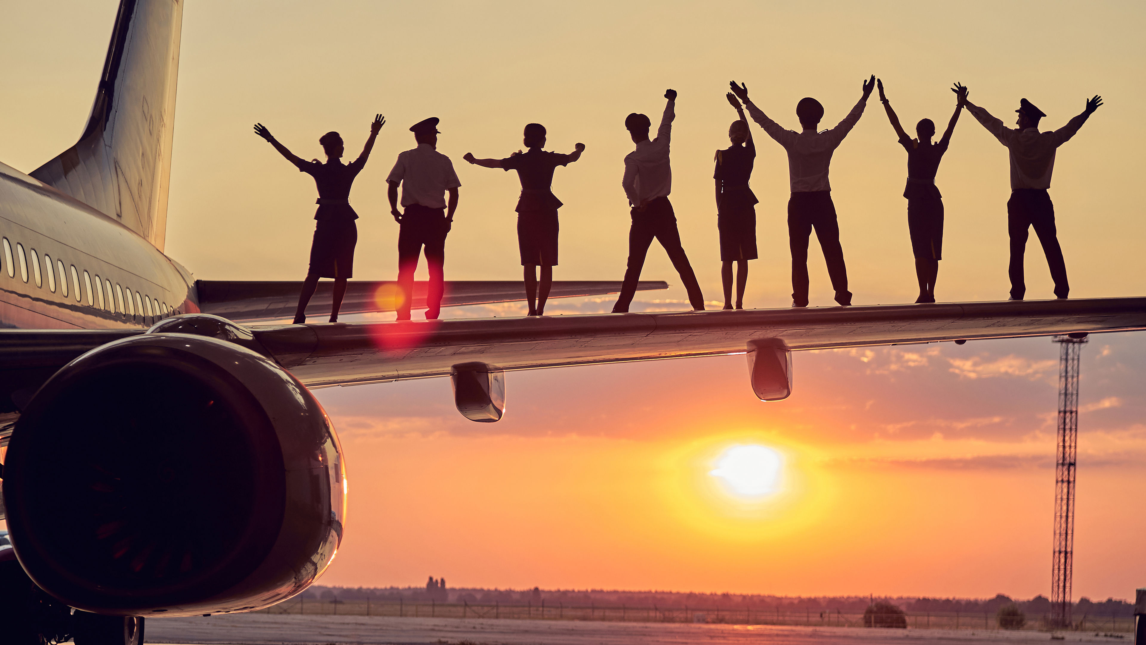 People hold hands on a wing.