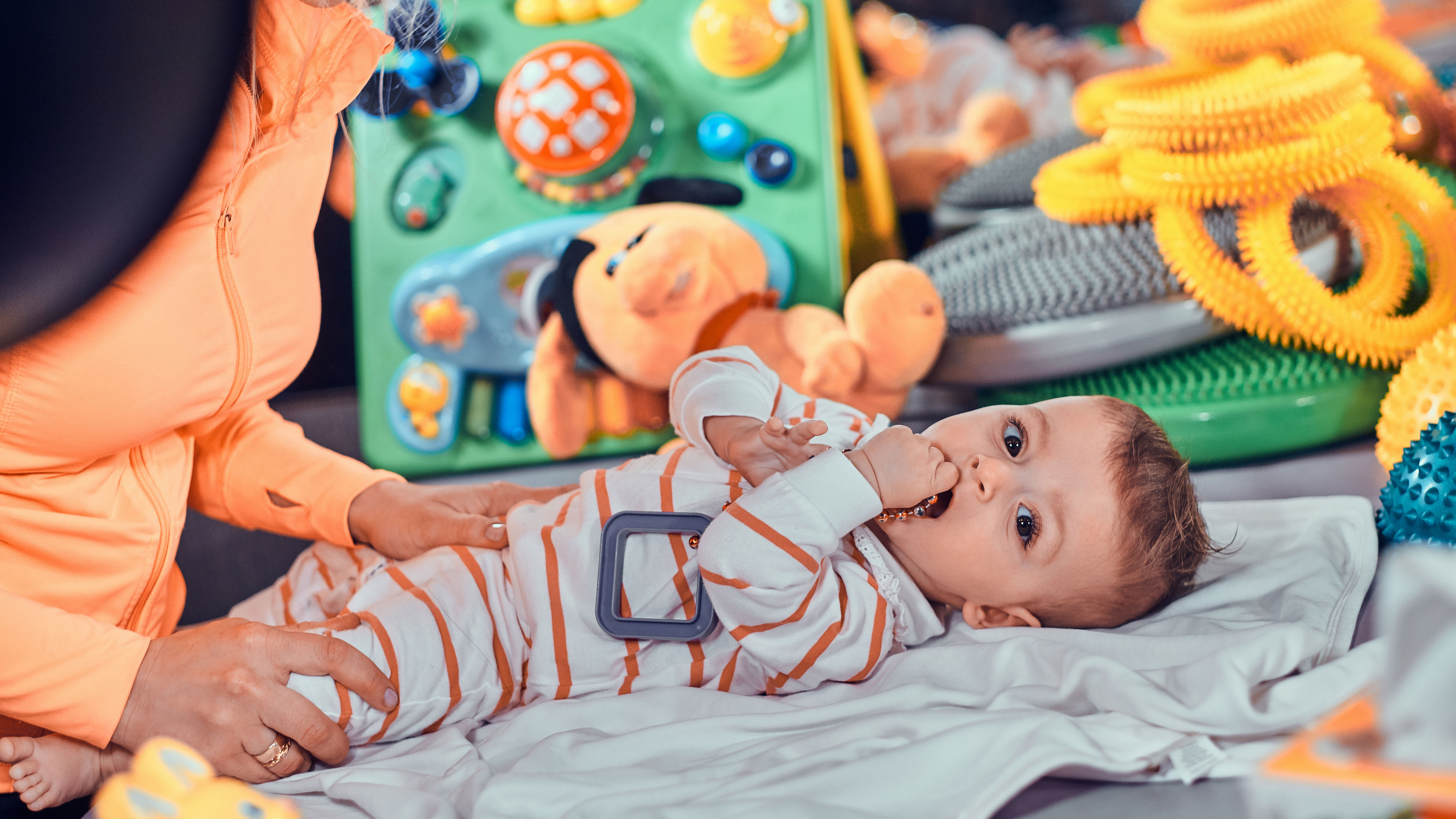 Happy smiling cute baby is lying in bed